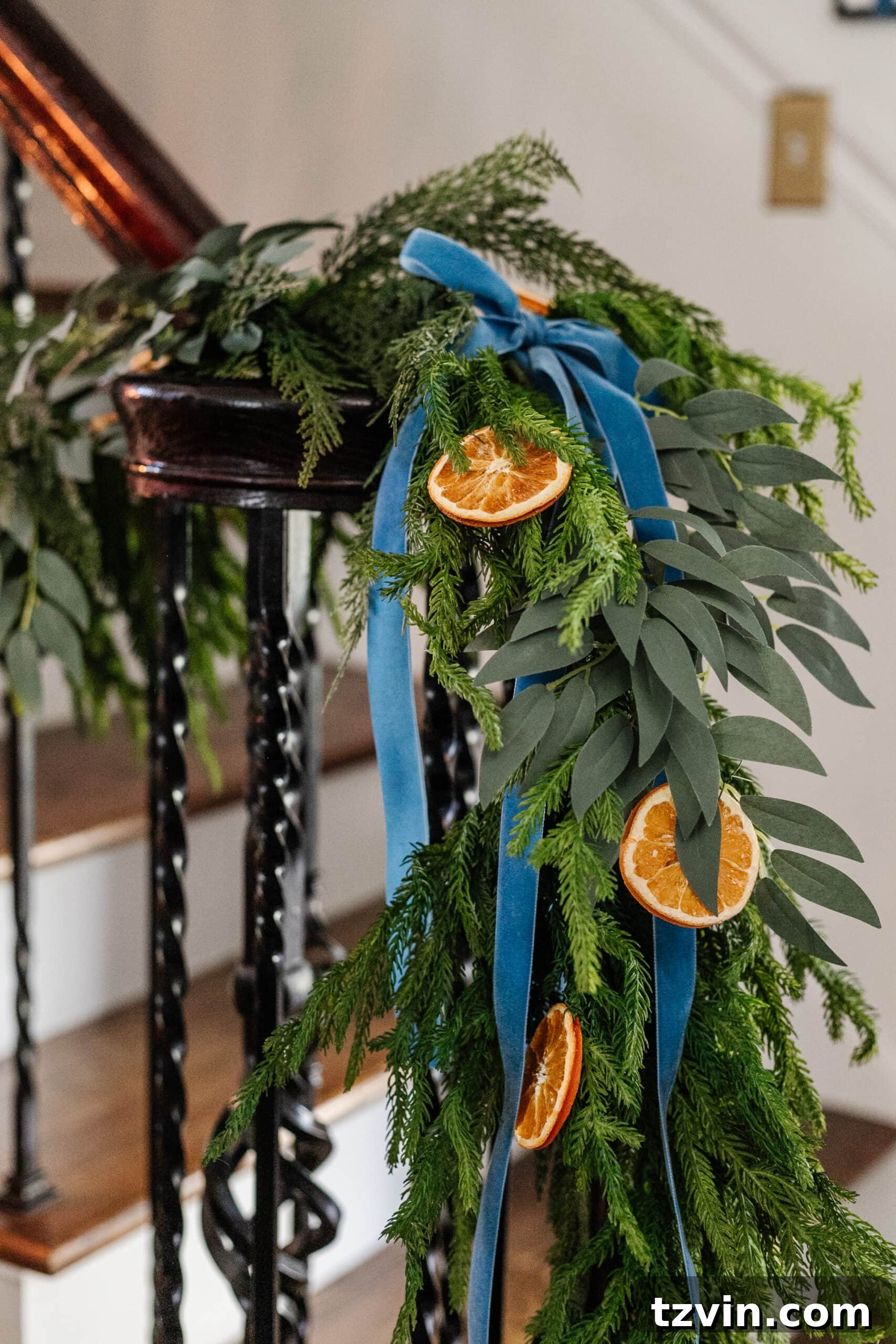 Sparkling Stairs and Welcoming Entryways: Your Garland Decor Guide 13 garland with dried oranges, eucalyptus, and blue ribbon