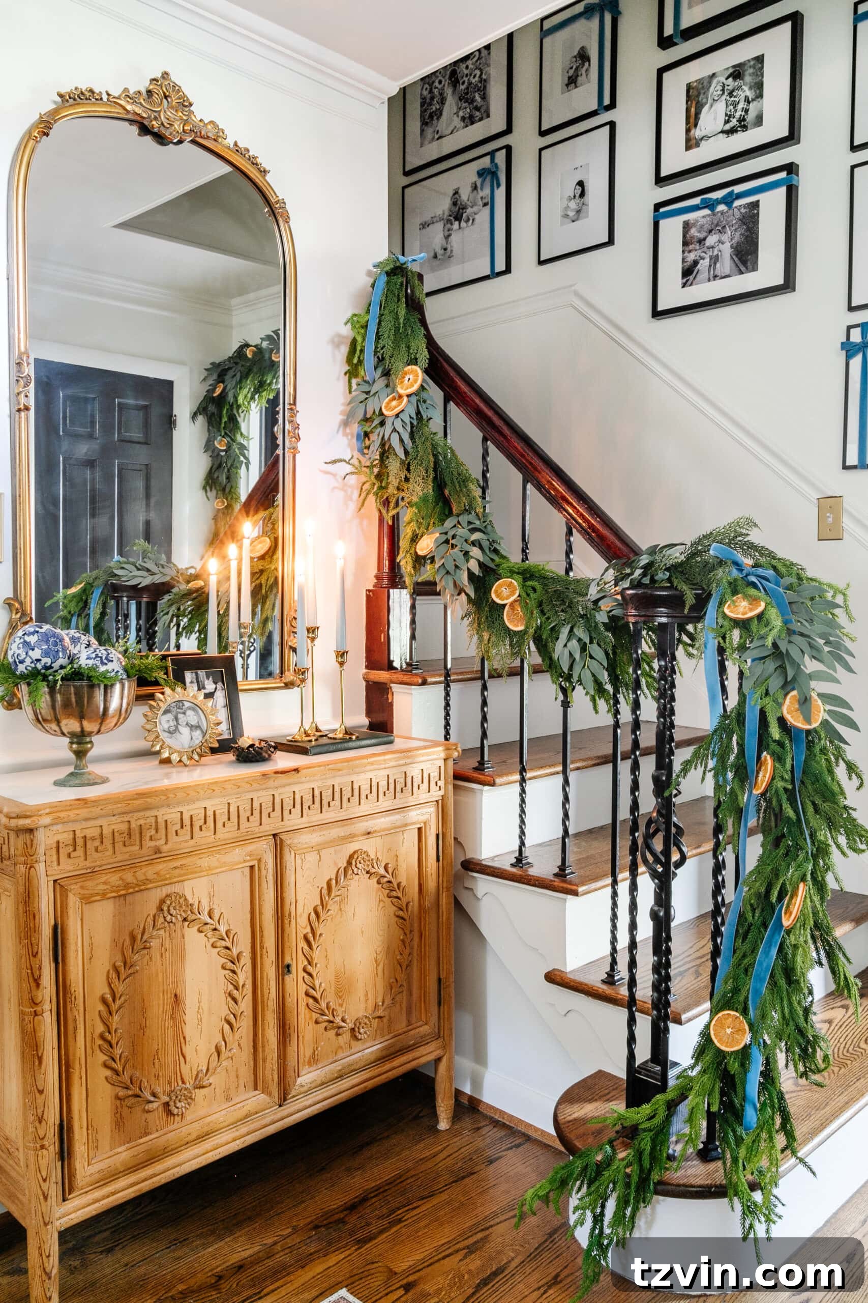 Sparkling Stairs and Welcoming Entryways: Your Garland Decor Guide 15 blue entryway Christmas decor with ribbon hanging from garland on stairs