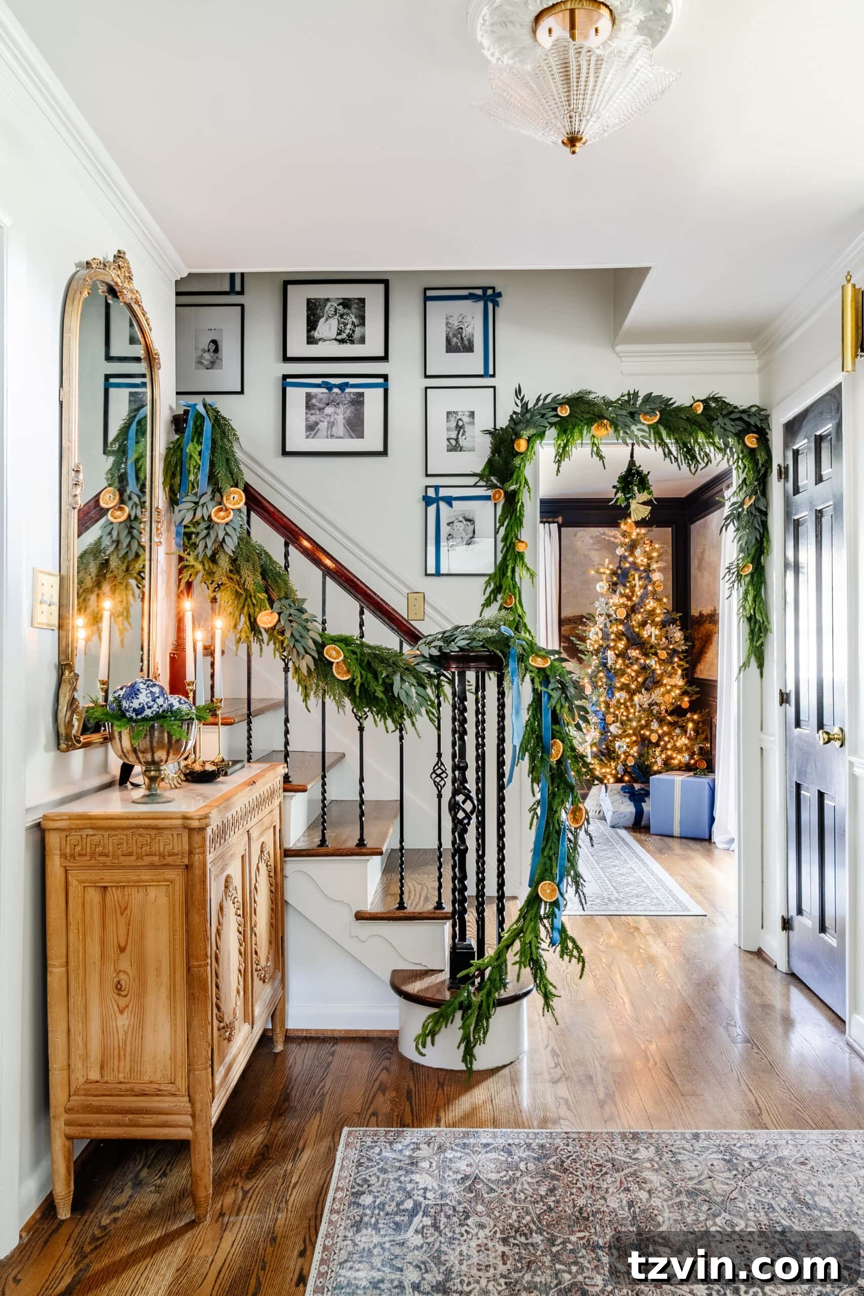Sparkling Stairs and Welcoming Entryways: Your Garland Decor Guide 20 blue entryway Christmas decor with Christmas tree peeking through doorway