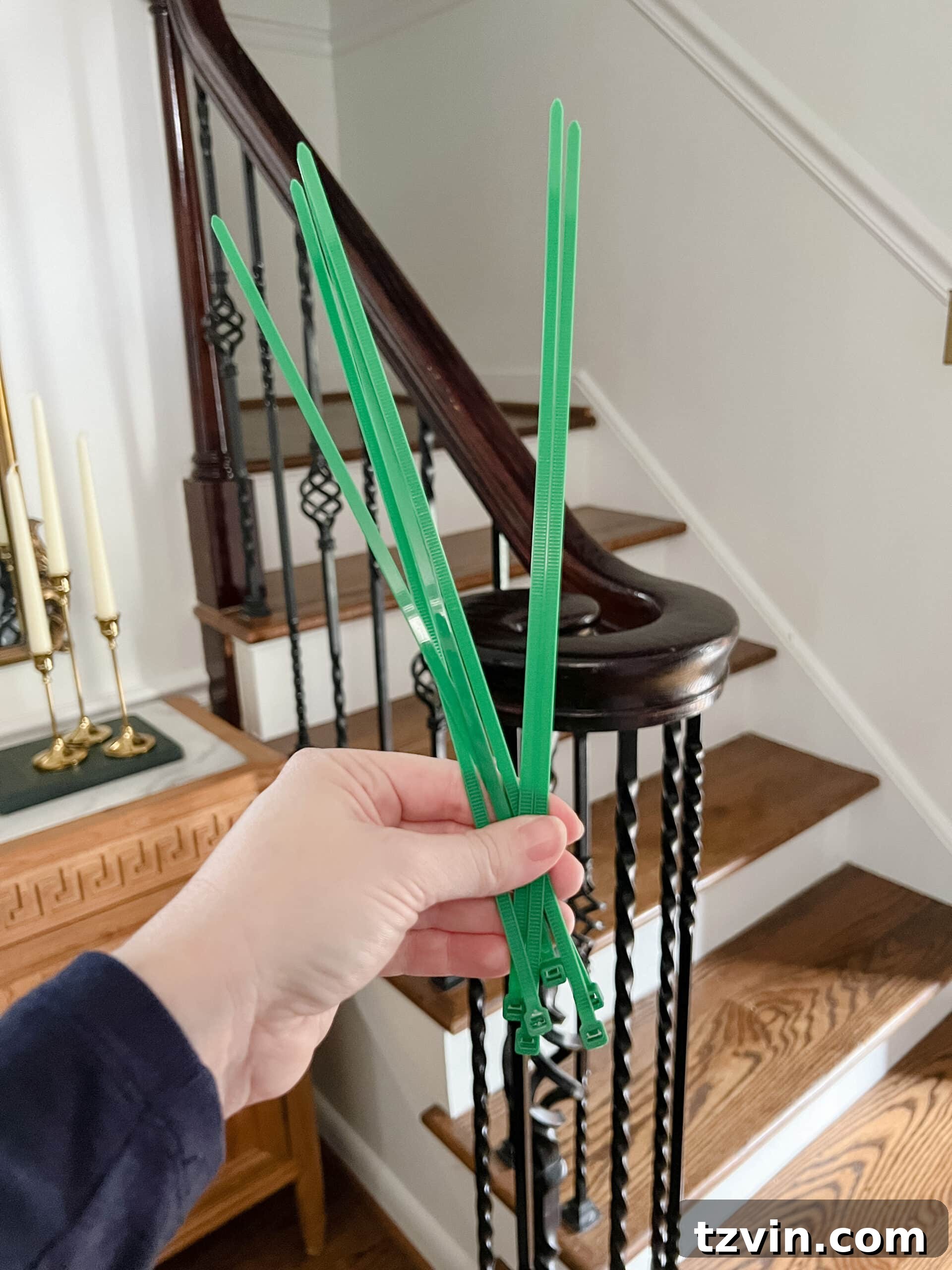 Sparkling Stairs and Welcoming Entryways: Your Garland Decor Guide 4 zip ties used for securely hanging garland on banister