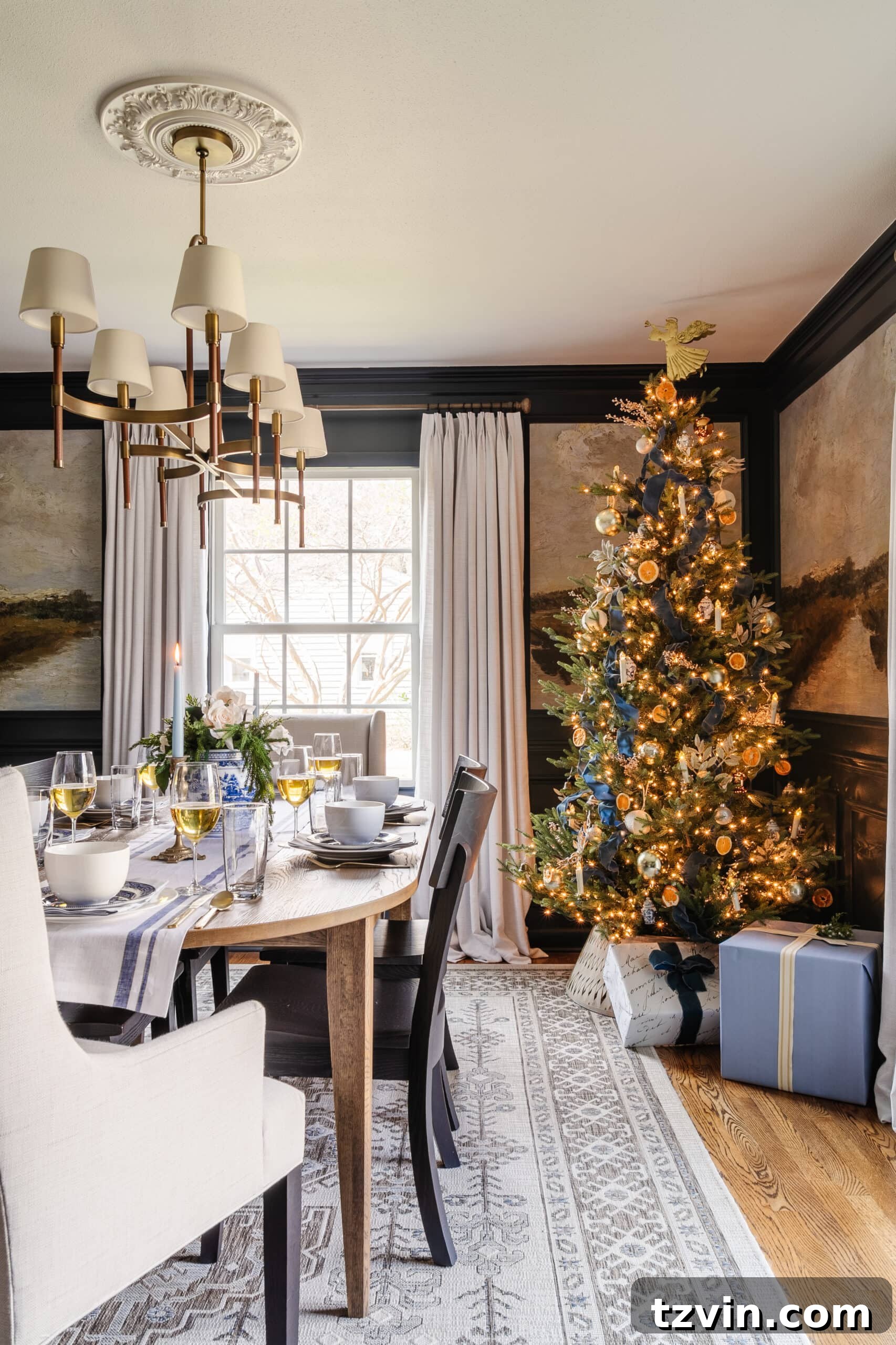 Festive Dining: White and Blue Christmas Inspiration 2 Elegant Christmas dining room with white and blue accents, a lit Christmas tree in the corner, and a beautifully set table.