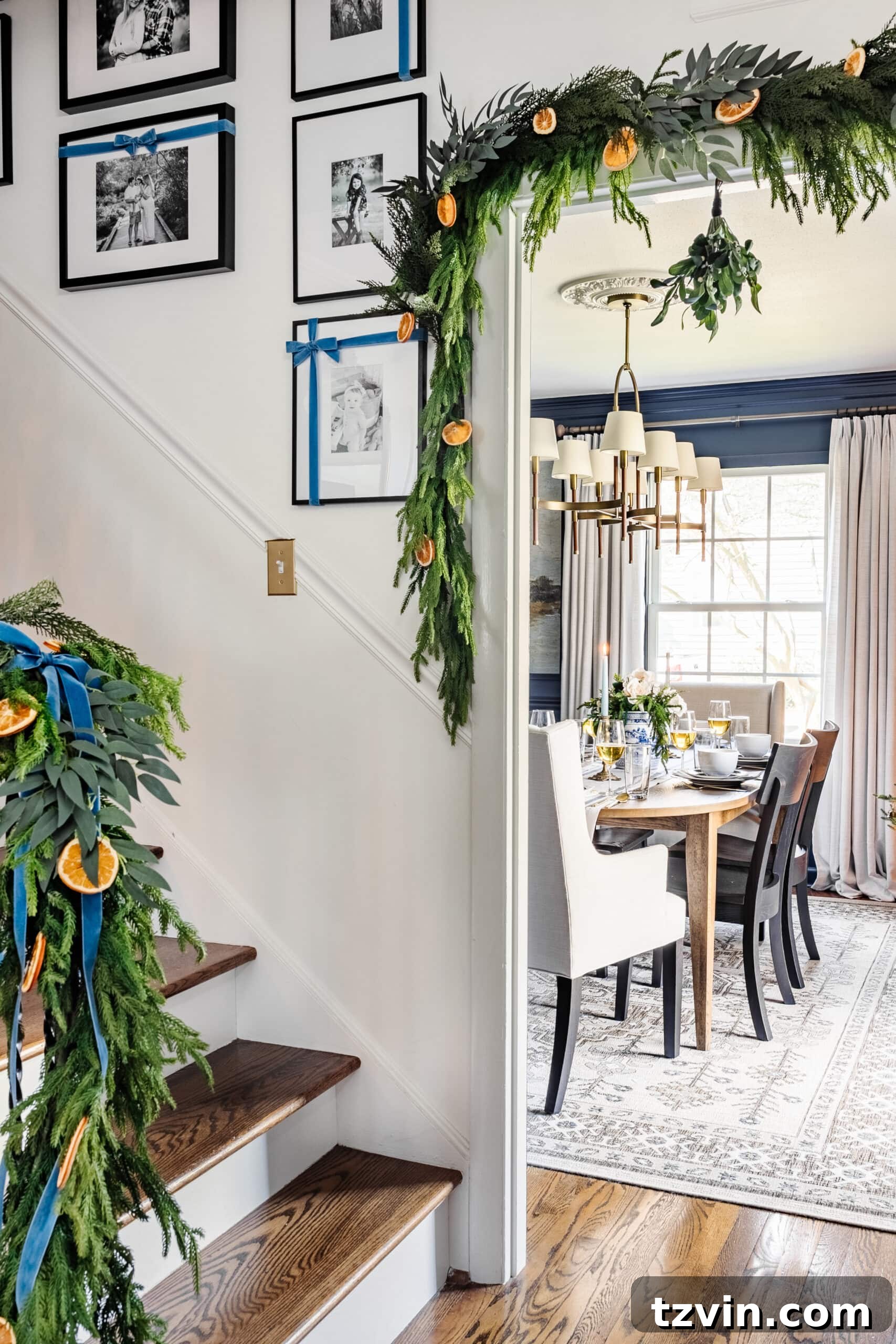 Festive Dining: White and Blue Christmas Inspiration 14 Peek of dining room with garland framing doorway.