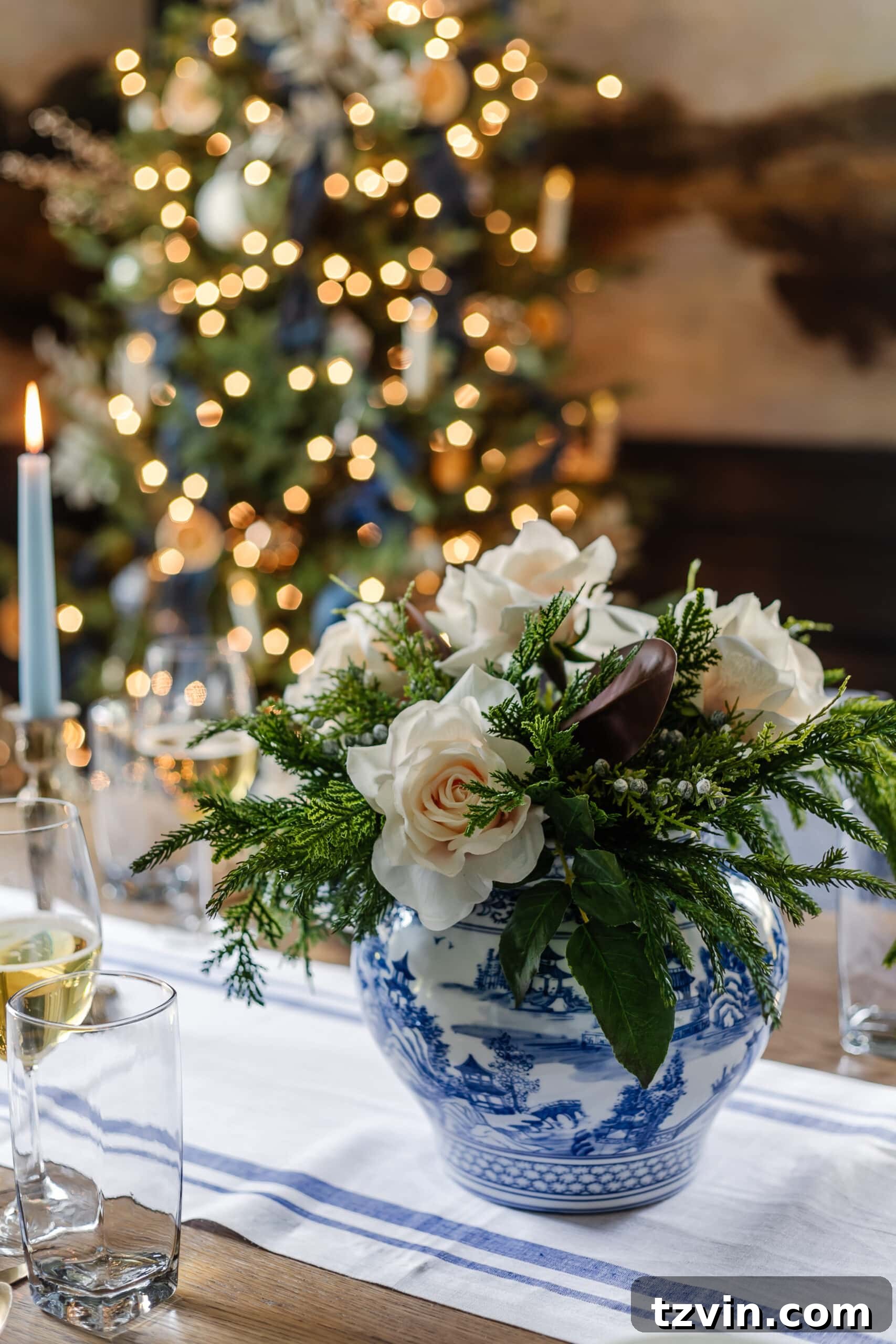 Festive Dining: White and Blue Christmas Inspiration 6 White and blue vase serving as a centerpiece on a Christmas dinner table.