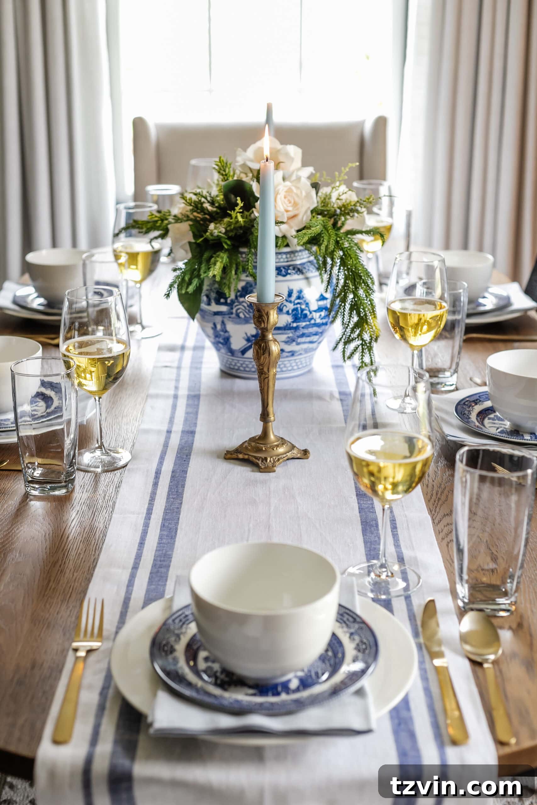 Festive Dining: White and Blue Christmas Inspiration 8 White and blue Christmas dinner table featuring a blue striped runner and blue candles.