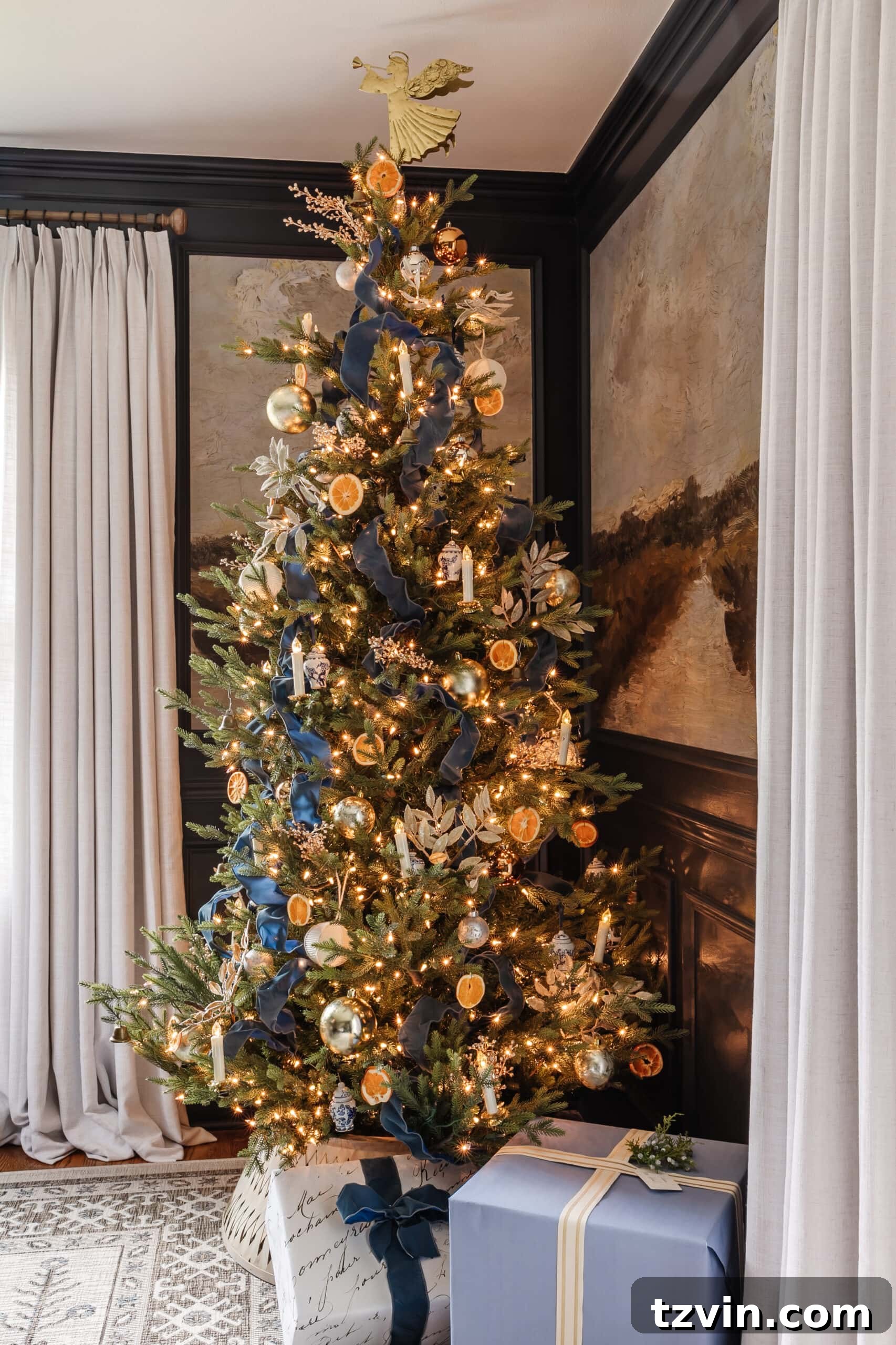 Festive Dining: White and Blue Christmas Inspiration 9 Blue Christmas tree decor featuring ribbon, metallic ornaments, and white and blue ornaments.