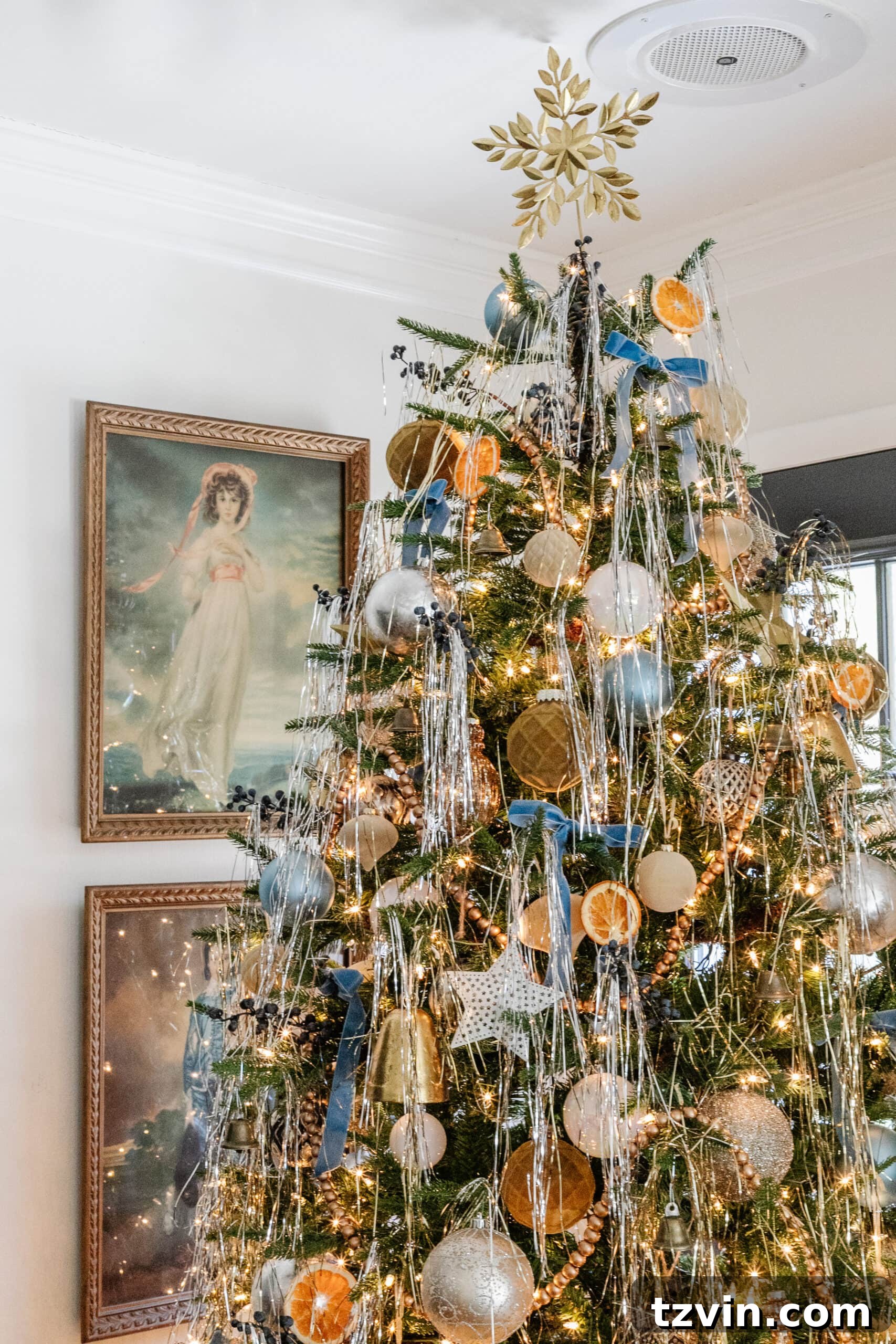 Snuggle-Worthy: 13 Christmas Living Room Decor Inspirations 14 pinkie and blue boy art beside a Christmas tree