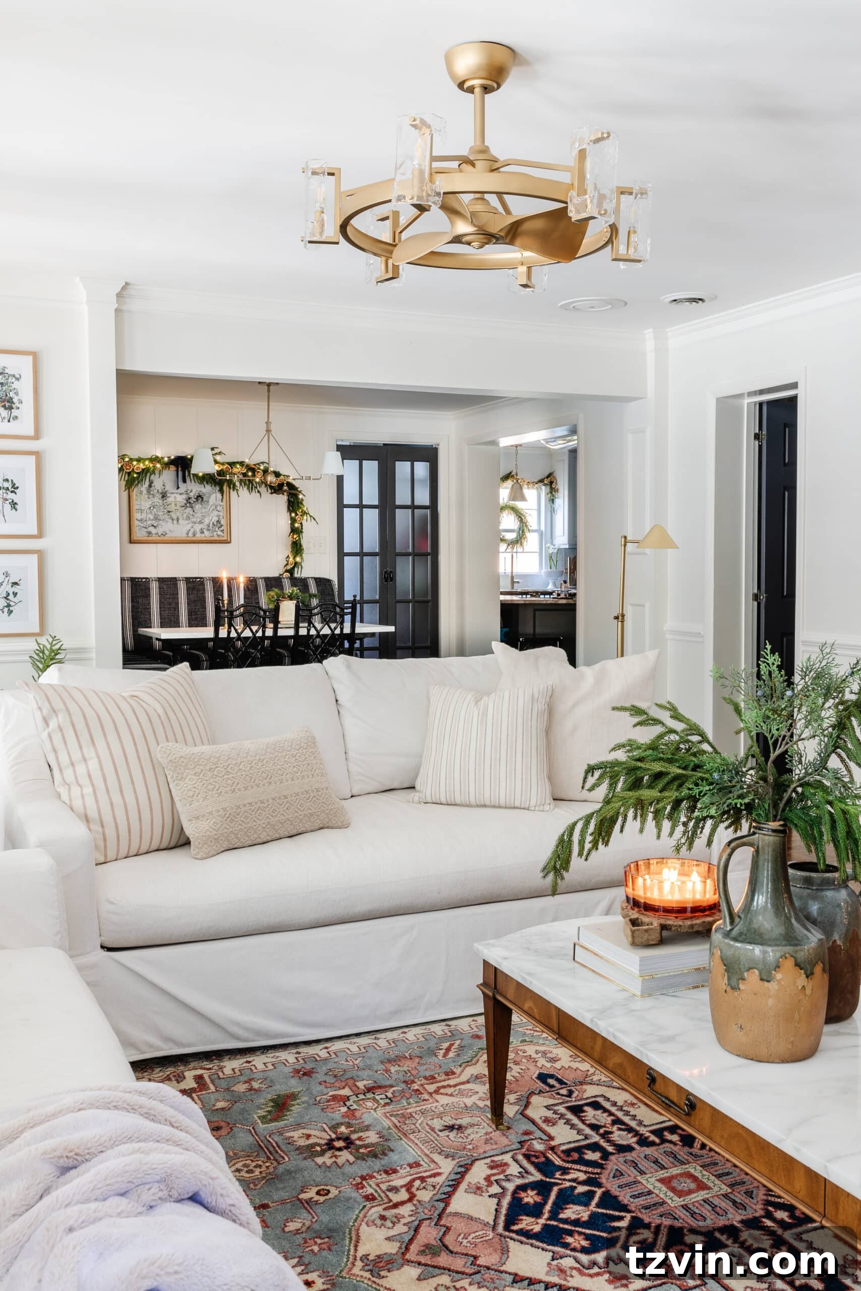 Snuggle-Worthy: 13 Christmas Living Room Decor Inspirations 17 white sofa with neutral pillows and vintage rug with Christmas decor on coffee table
