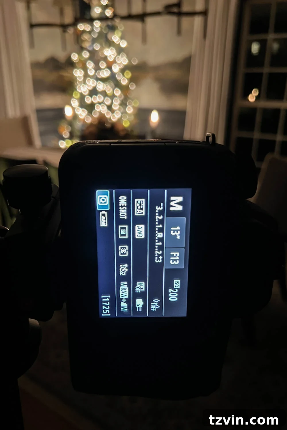 A camera setup on a tripod, demonstrating the aperture setting for wide room photography at night.