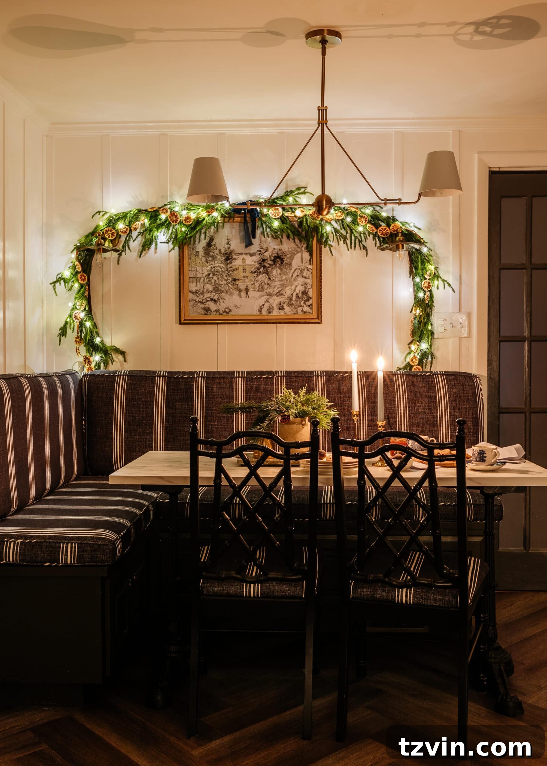 A breakfast nook decorated with Christmas garland and candles, captured with a wide aperture to keep all elements in focus.