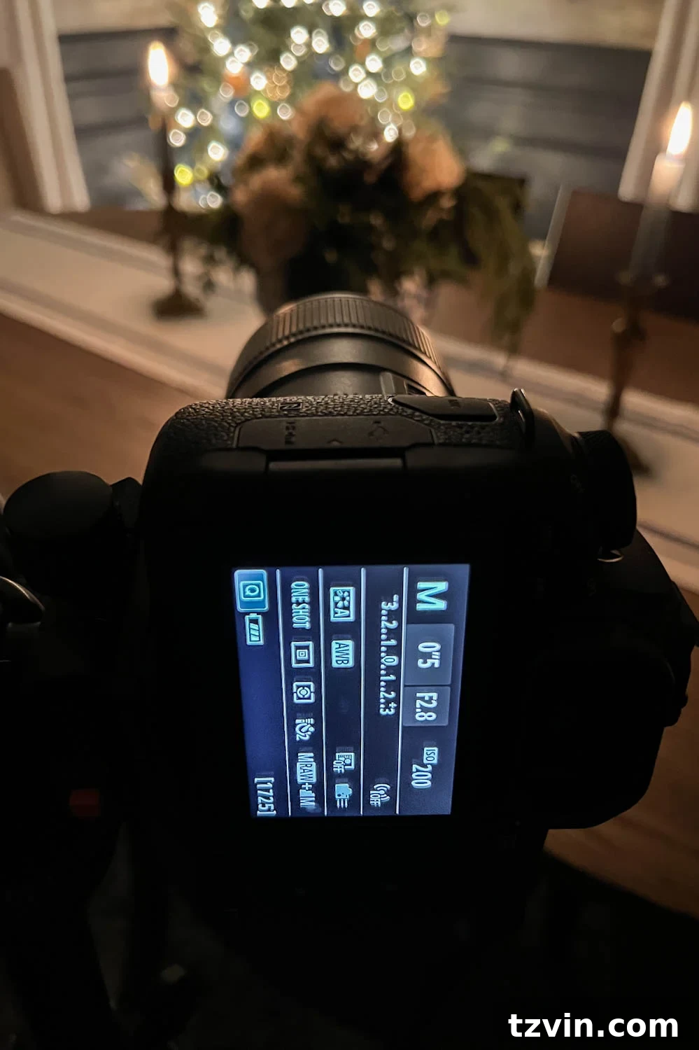 A camera with a prime lens, set to a wide aperture for capturing close-ups with a creamy bokeh effect against a backdrop of Christmas lights.