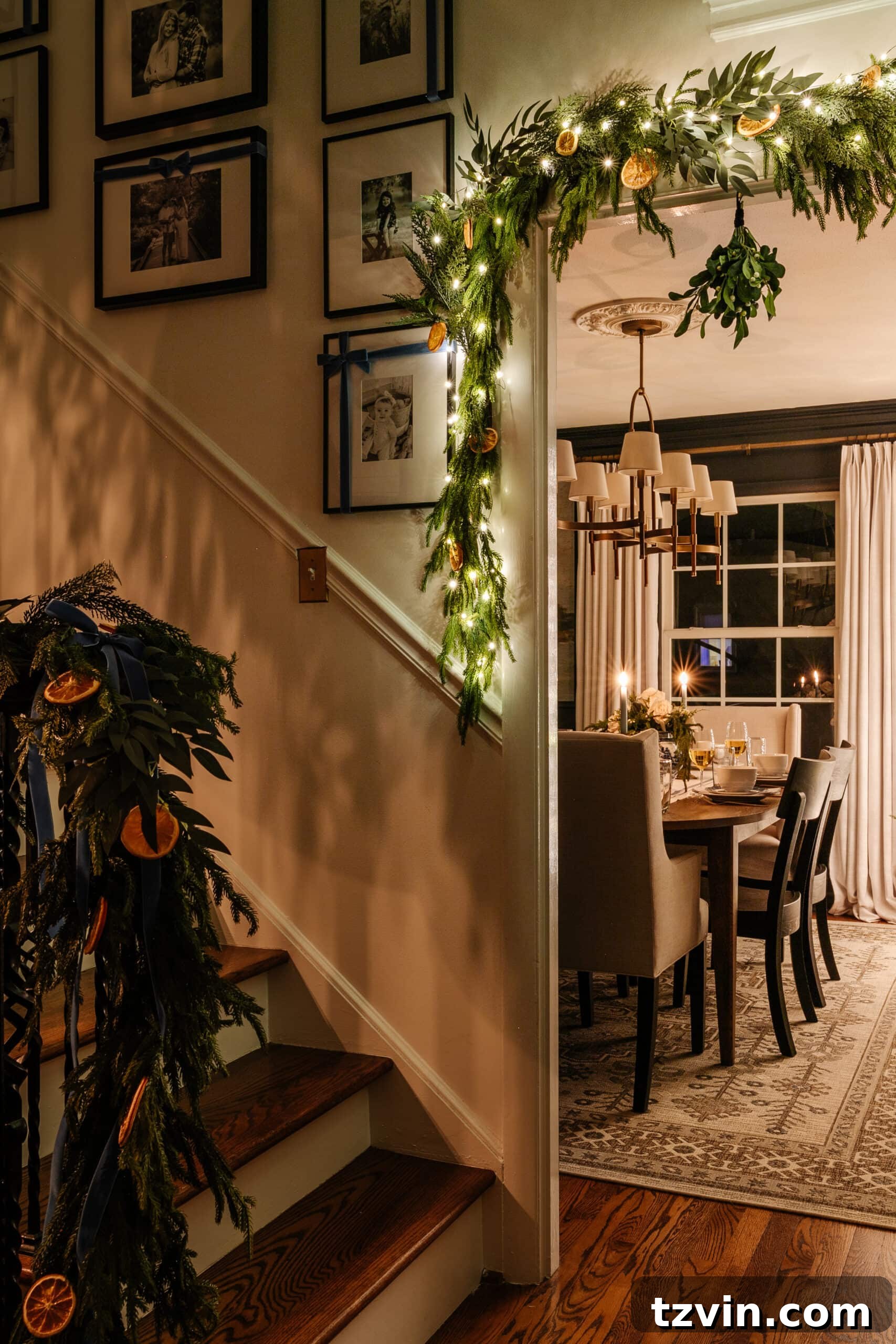 Candles on an entryway table cast soft shadows, adding depth to a festive room illuminated by Christmas lights.