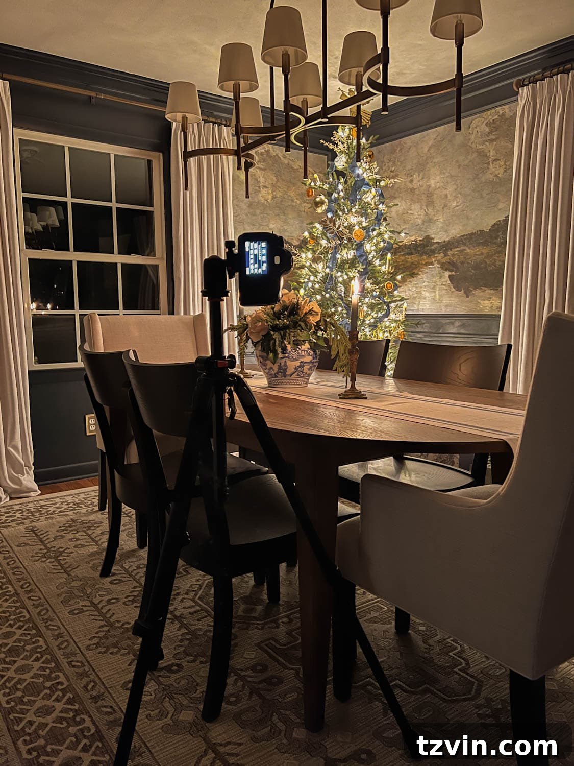 A photographer uses a tripod to steady a camera, focusing on a beautifully decorated Christmas tree, emphasizing stable shooting.
