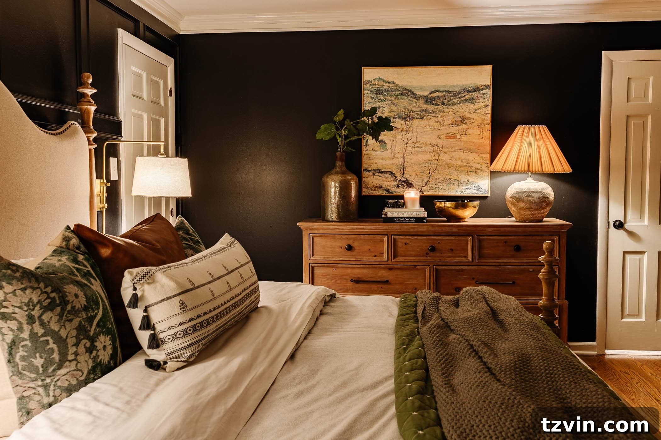 cozy winter bedroom decor with green bedding and lamp on dresser