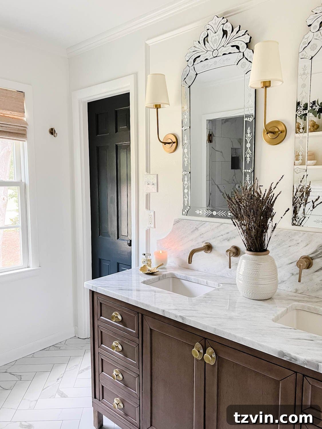 Parisian bathroom with white walls, black door, wood vanity, and marble countertop