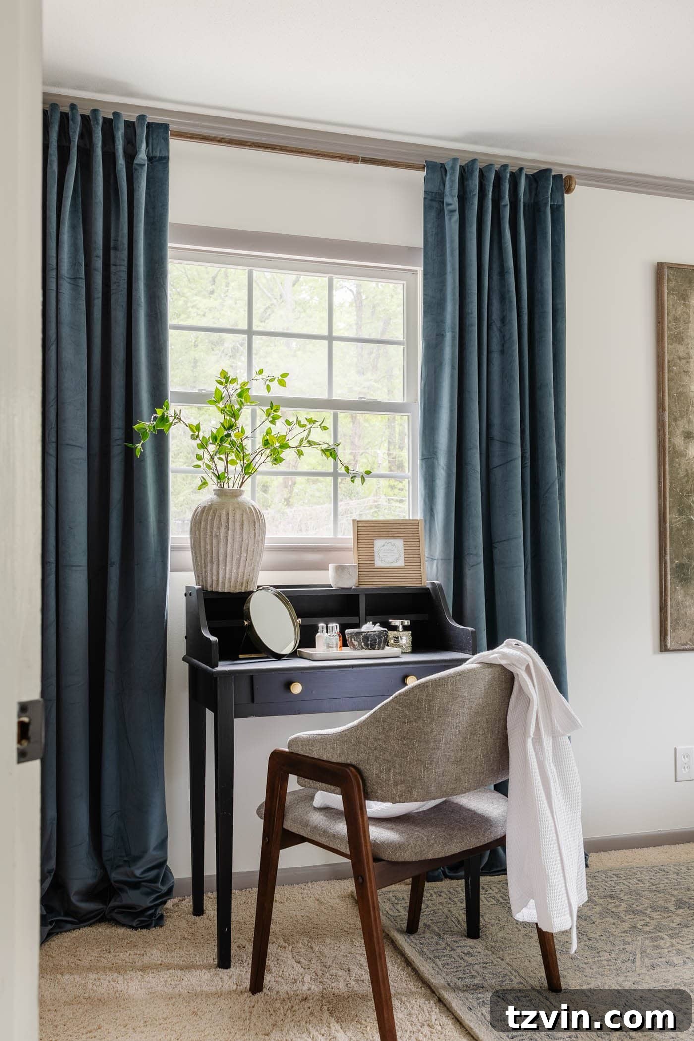 black writing desk / vanity in a bedroom with blue velvet curtains