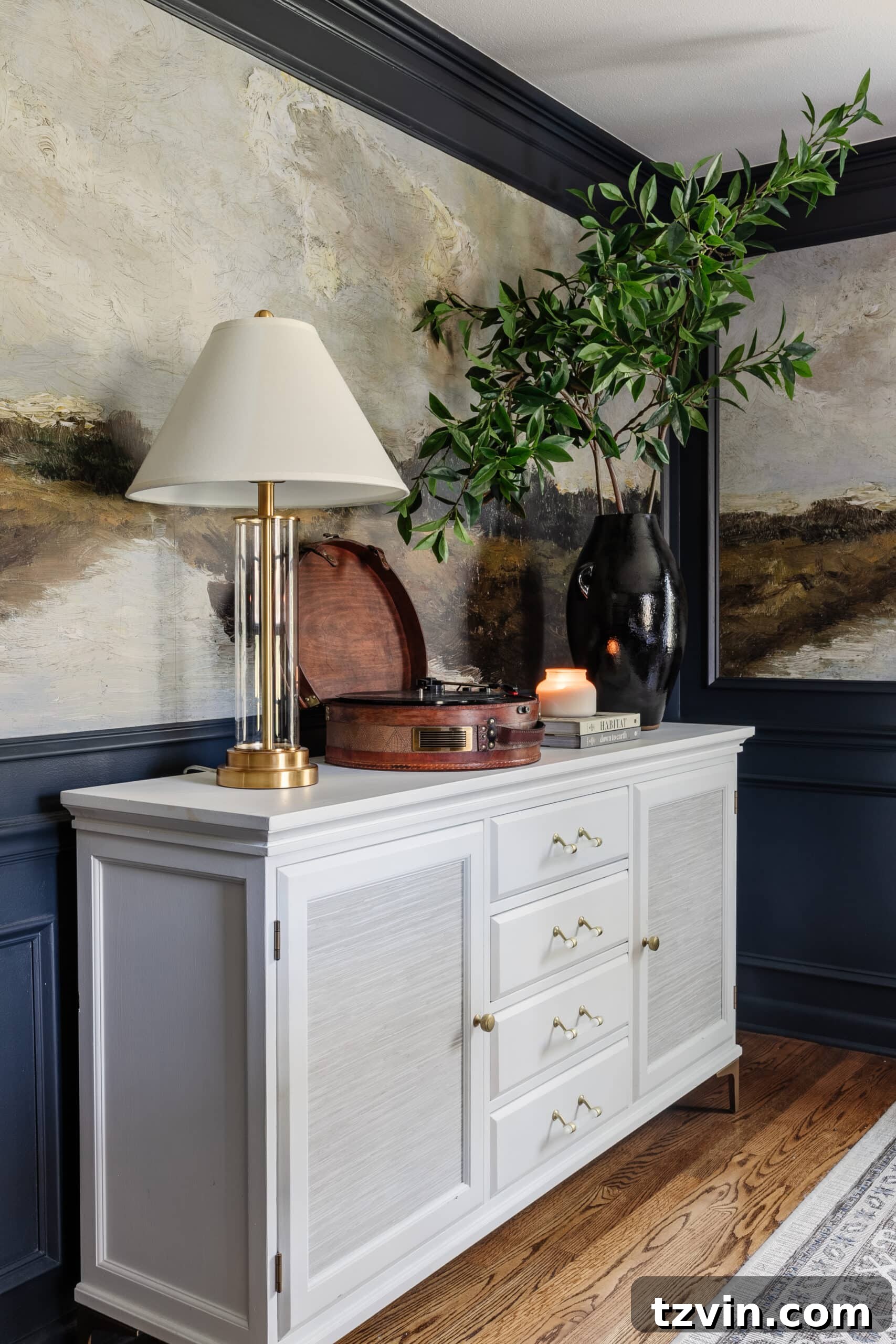 white buffet in a dining room with navy walls and scenic mural wallpaper