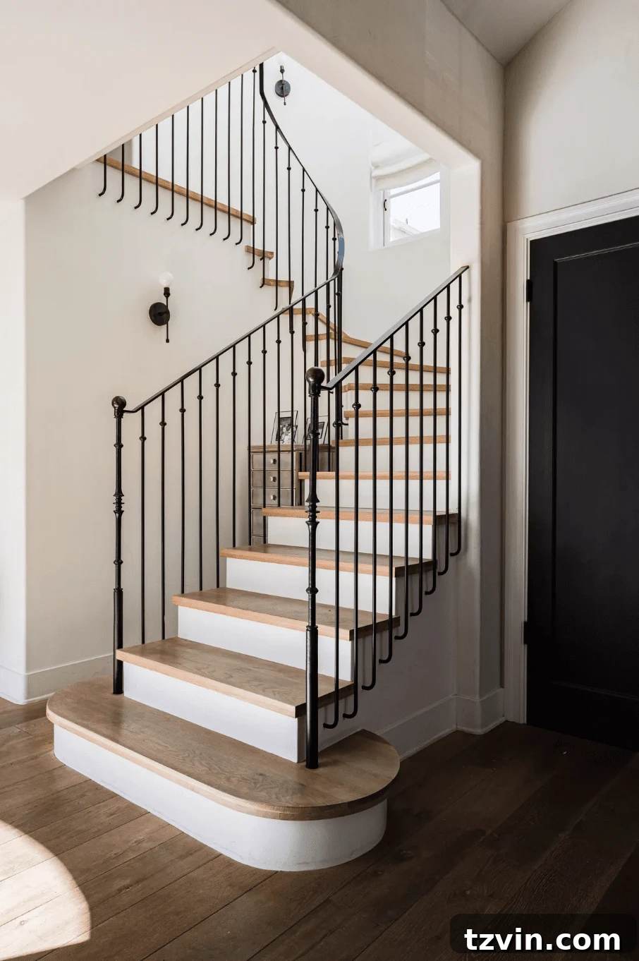 Black Stair Railing Ideas for a Dramatic Entry 7 wrought iron black stair railing with white risers and wood treads