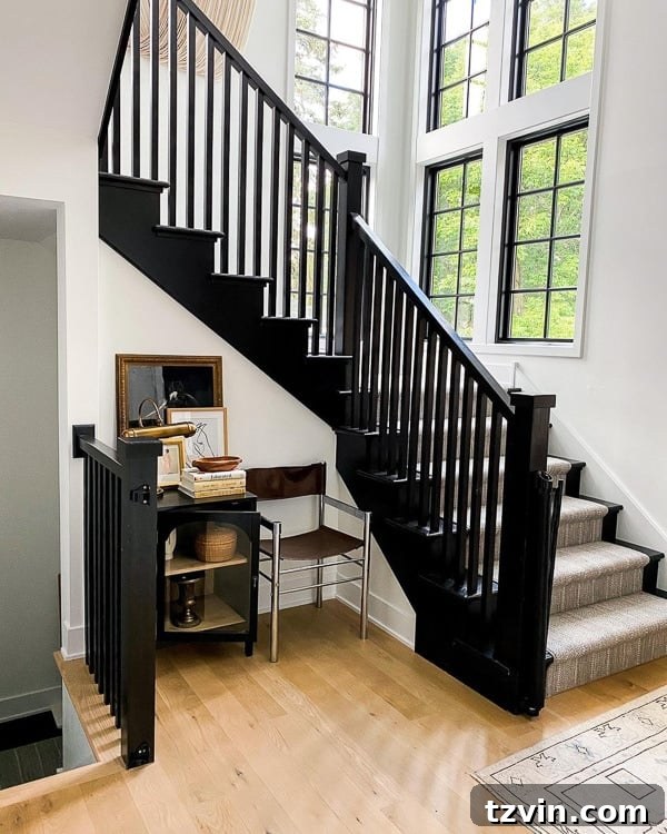 Black Stair Railing Ideas for a Dramatic Entry 9 black painted staircase with neutral striped rug