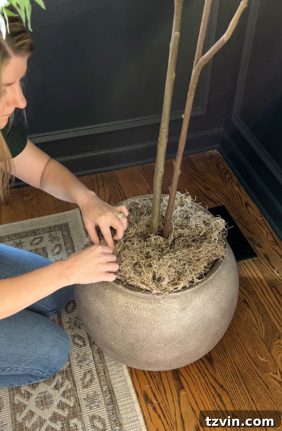 Beyond Plastic: Making Your Artificial Indoor Trees Look Naturally Real 5 placing a fake tree in a large planter with moss to look real