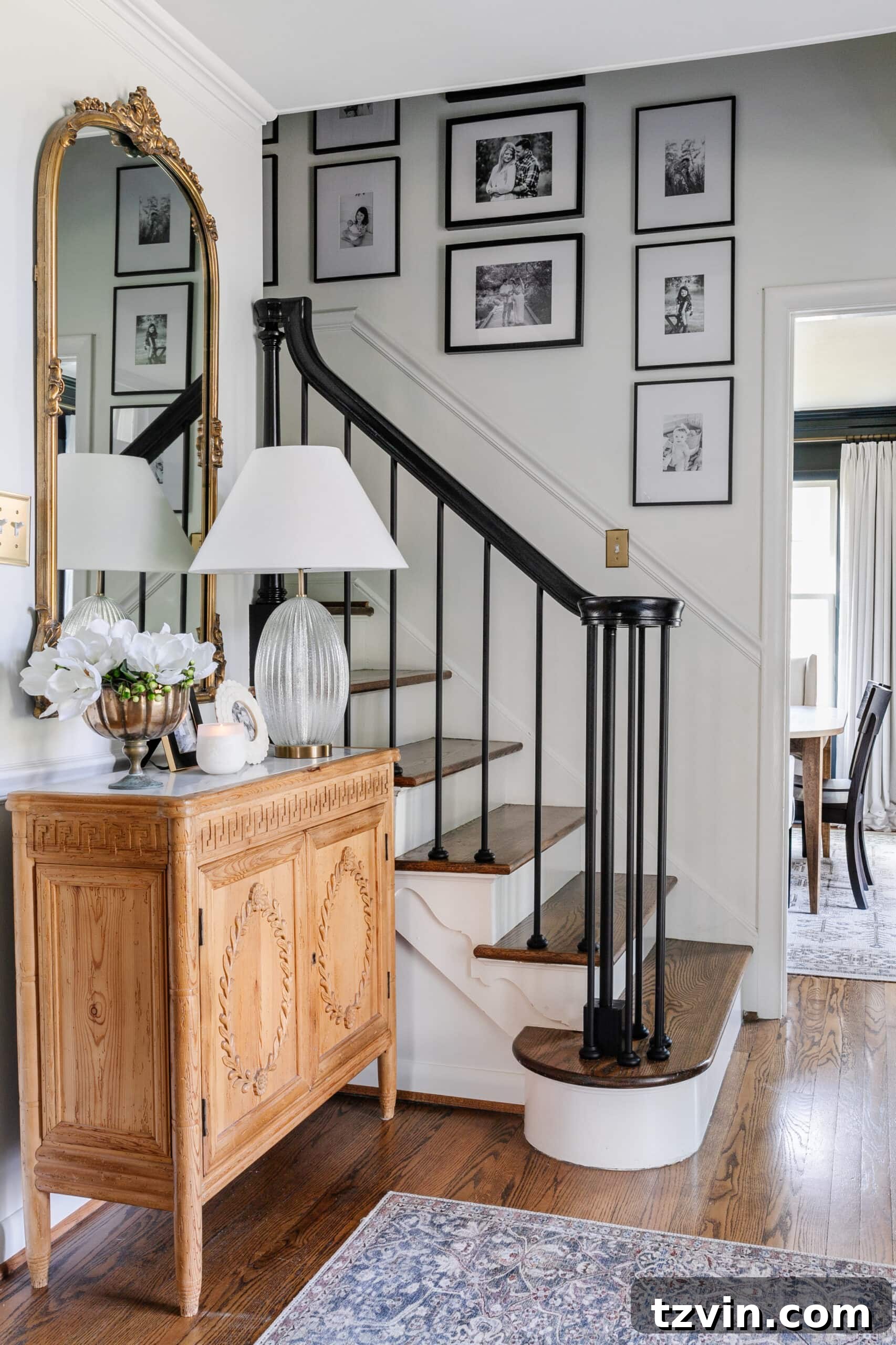 Revamp Your Stairs: DIY Spindle Replacement 2 foyer with small staircase with black stair railing and family gallery wall