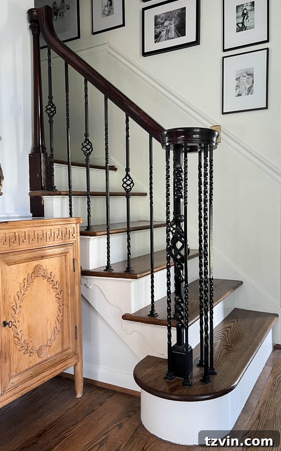 Revamp Your Stairs: DIY Spindle Replacement 3 twisted iron balusters on a railing before makeover