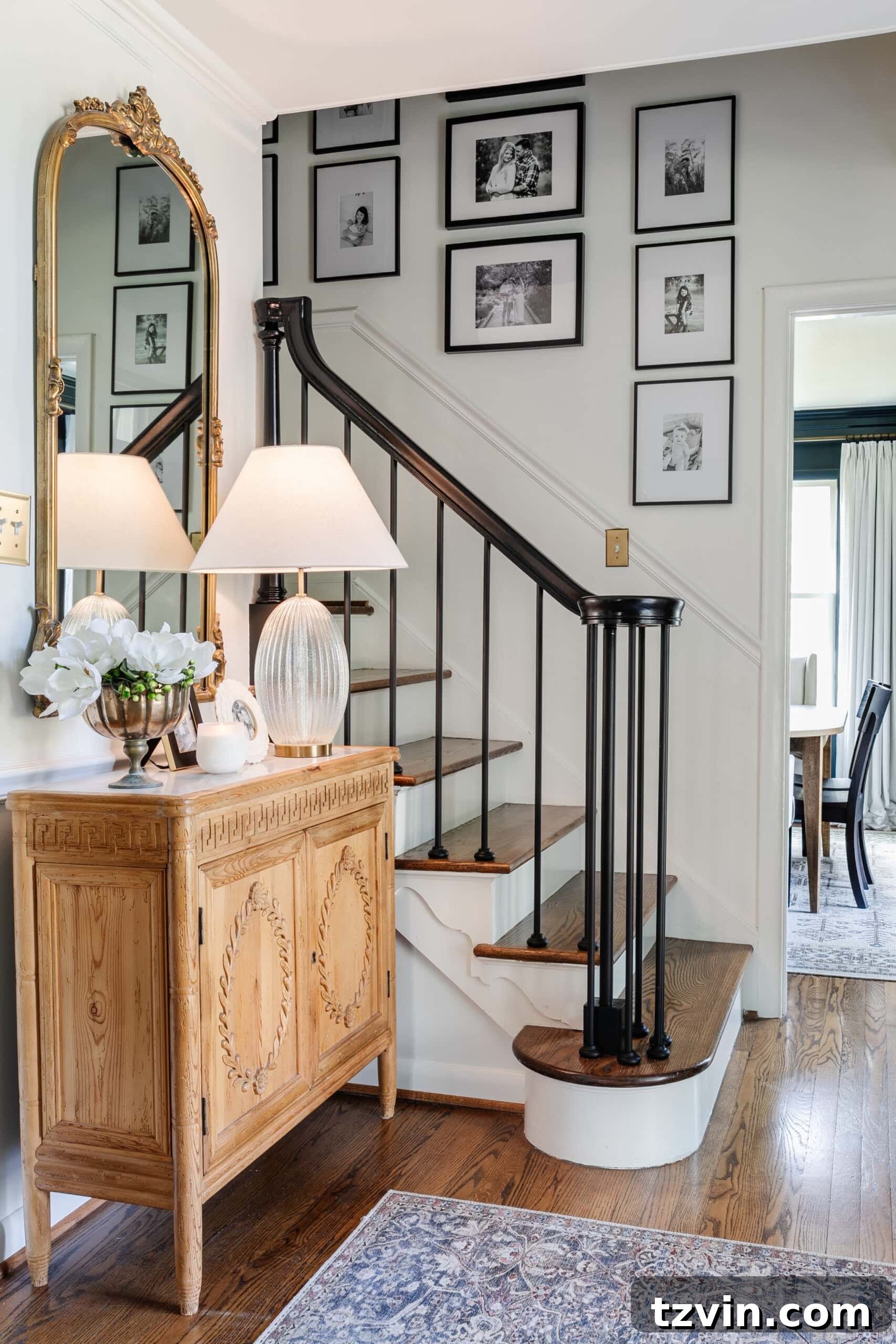 Revamp Your Stairs: DIY Spindle Replacement 31 classic foyer with carved wood credenza, black stair railing, and family gallery wall on stairs