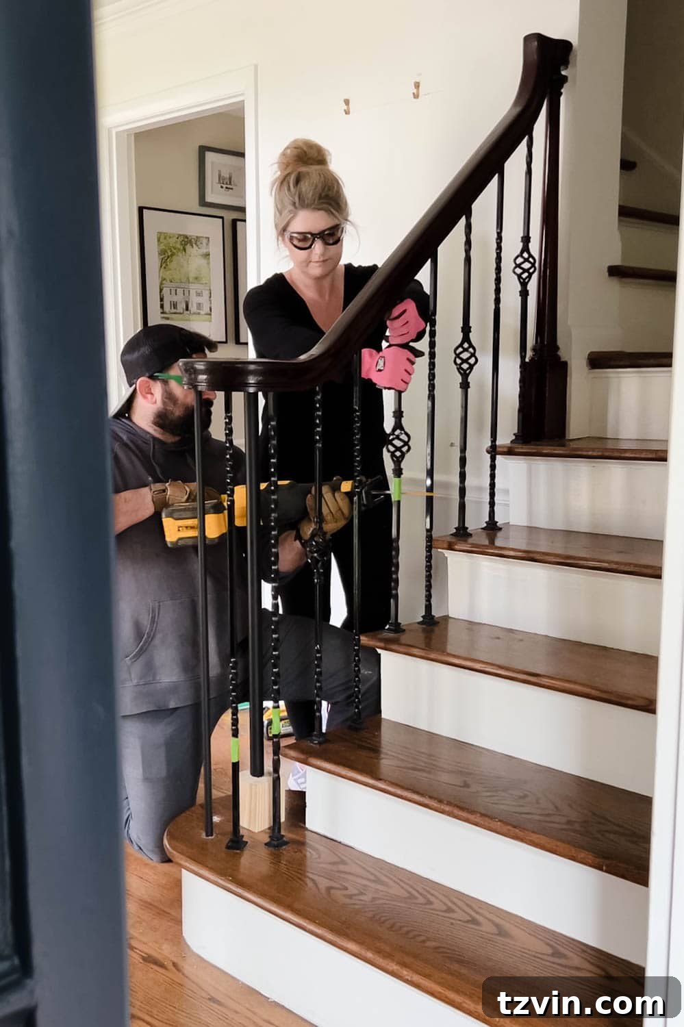 Revamp Your Stairs: DIY Spindle Replacement 8 couple working together to remove old stair spindles from railing