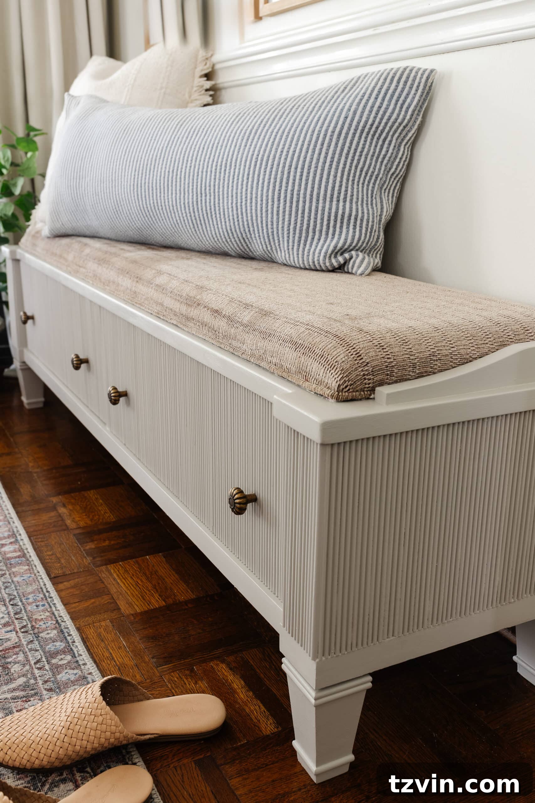 Reeded Elegance: A Shoe Storage Bench Makeover 17 Decorative reeding applied to a storage bench in an entryway, painted in Sherwin Williams Anew Gray, featuring elegant new brass hardware