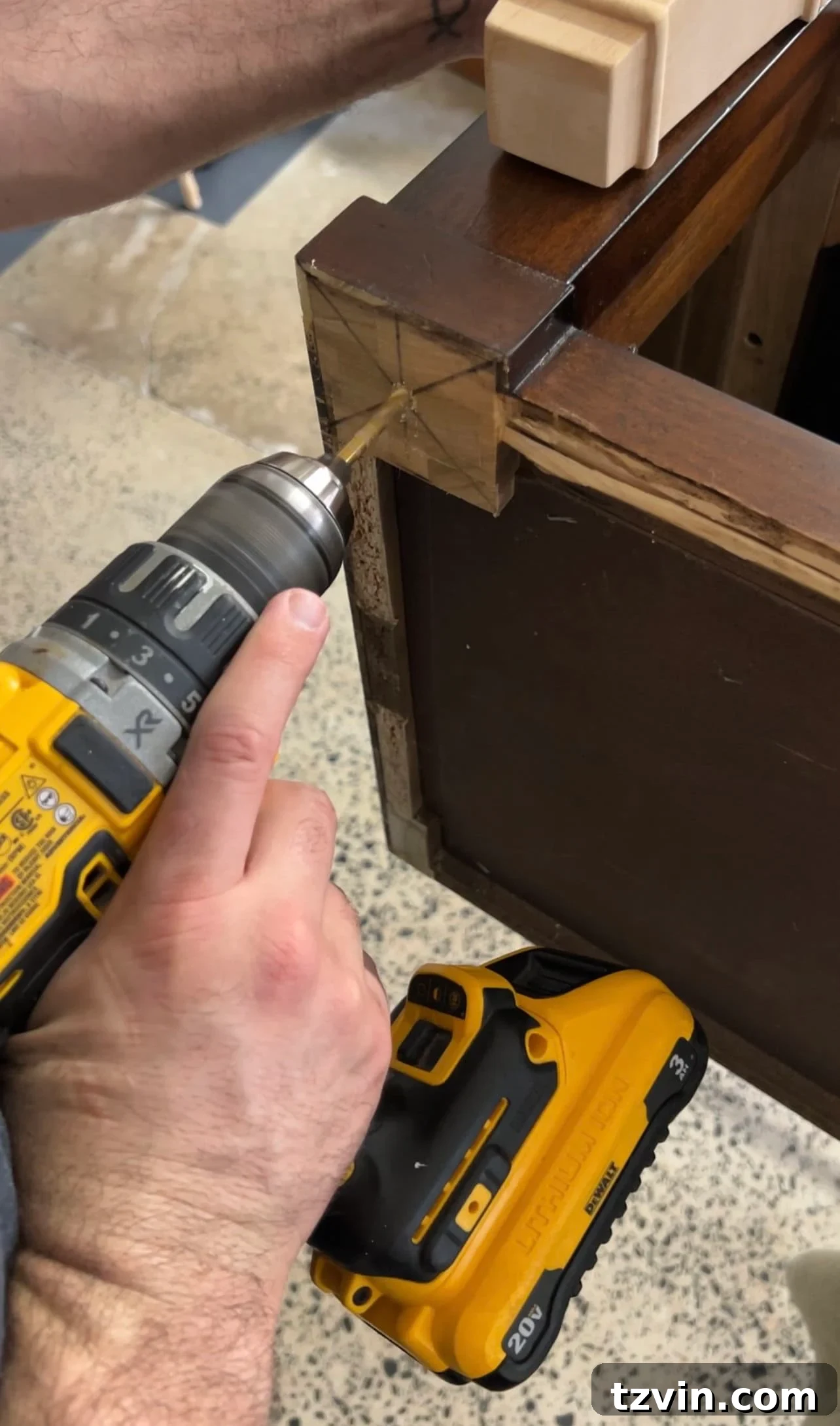 Reeded Elegance: A Shoe Storage Bench Makeover 10 Detailed shot of drilling pilot holes into the bench base to securely attach new furniture legs