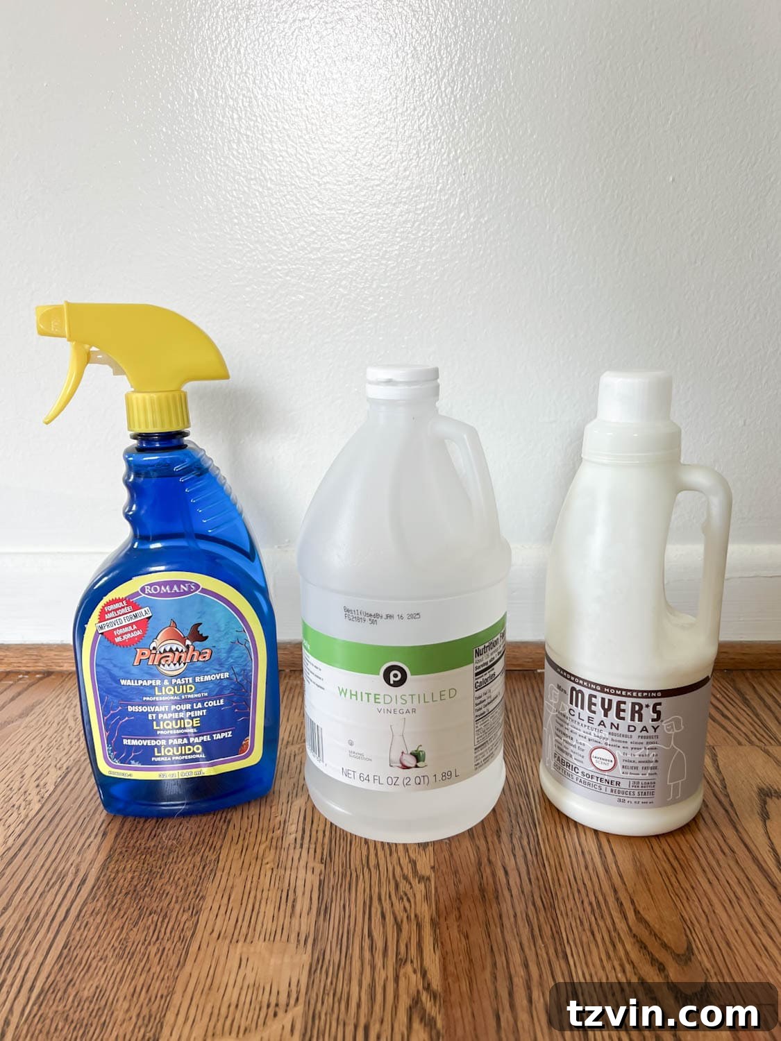 Testing different wallpaper remover solutions: store-bought, vinegar, and fabric softener