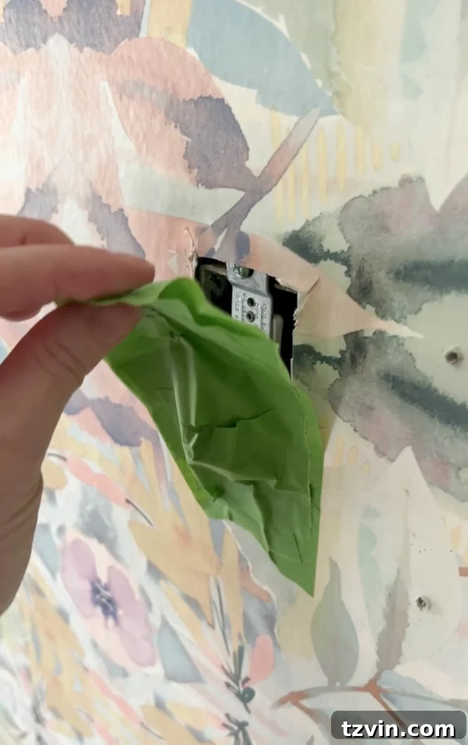 Covering electrical outlets before wallpaper removal to protect wires from water