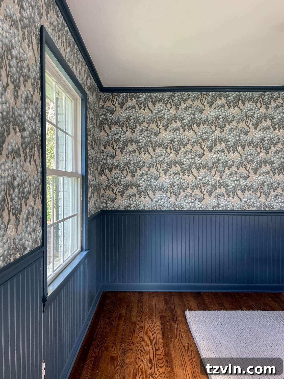 Unleash Maximalism: 30 Vintage Scandinavian Wallpaper Designs 2 Maximalist decor featuring beadboard painted Sherwin Williams Smoky Blue and a stunning vintage Scandinavian wallpaper pattern, Sandberg Wallpaper Ragnvi Indigo Blue.