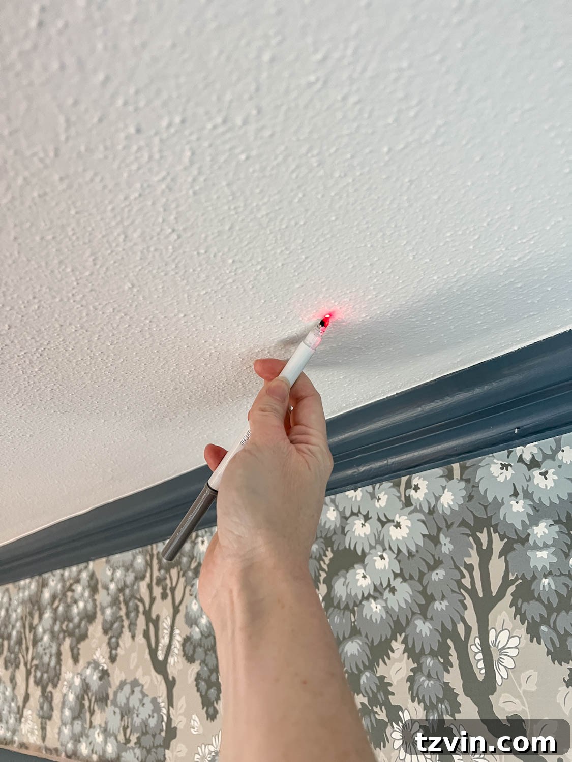 Craft Faux Block Print Ceilings Using Vinyl Decals 7 Using a laser level to accurately mark vinyl decal placement points on a ceiling.