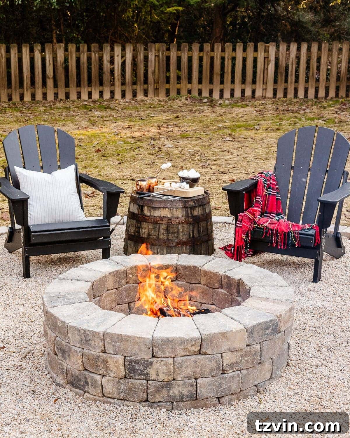 diy stone fire pit in a backyard with adirondack chairs