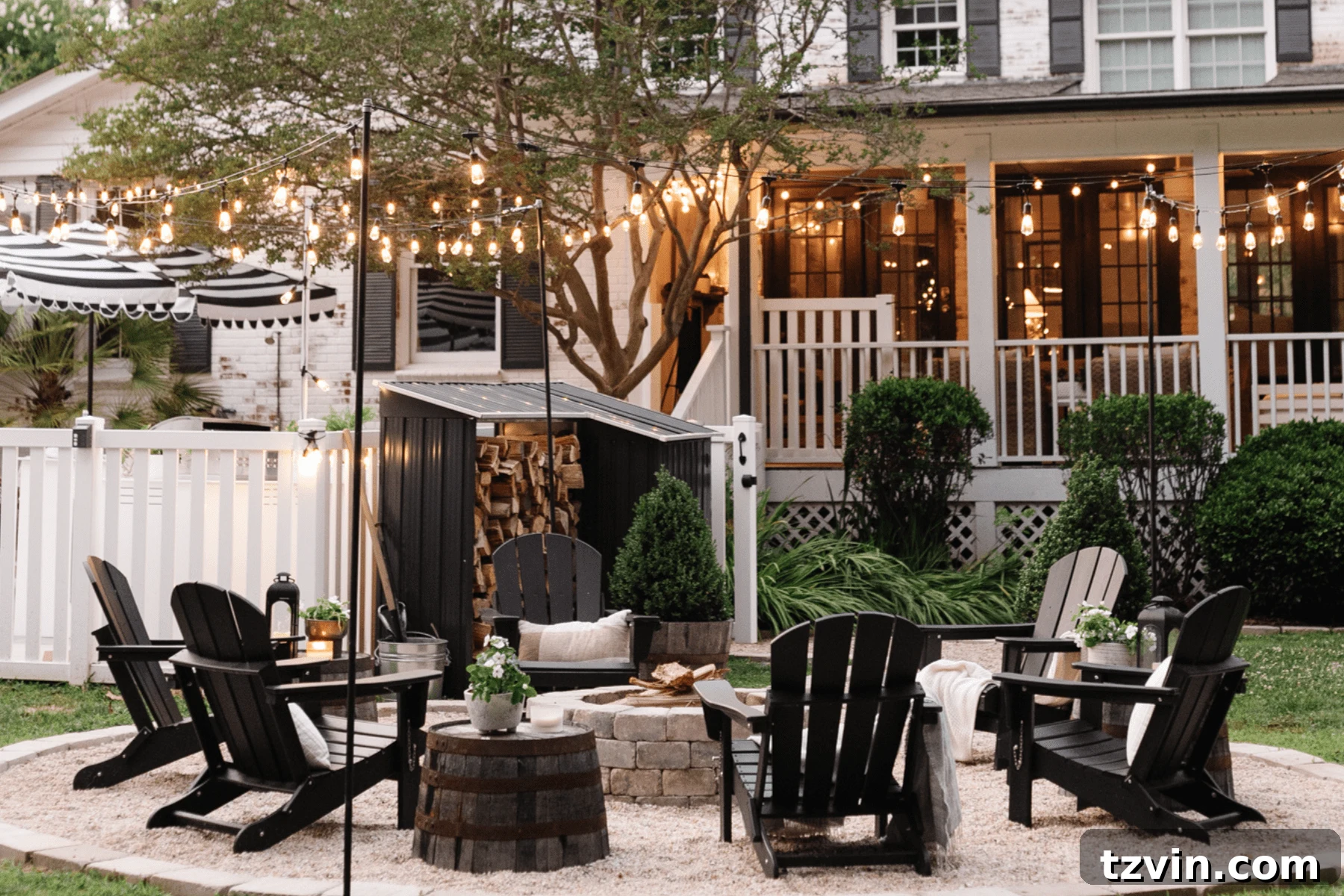 backyard fire pit with string lights and pea gravel conversation area