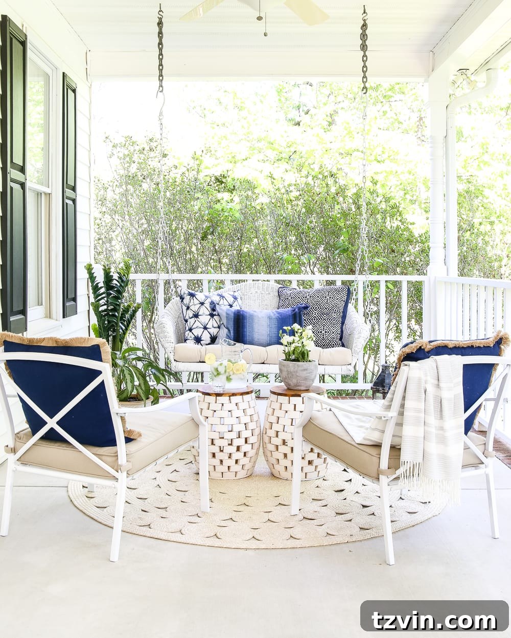 swing and chairs in a conversation area on a porch