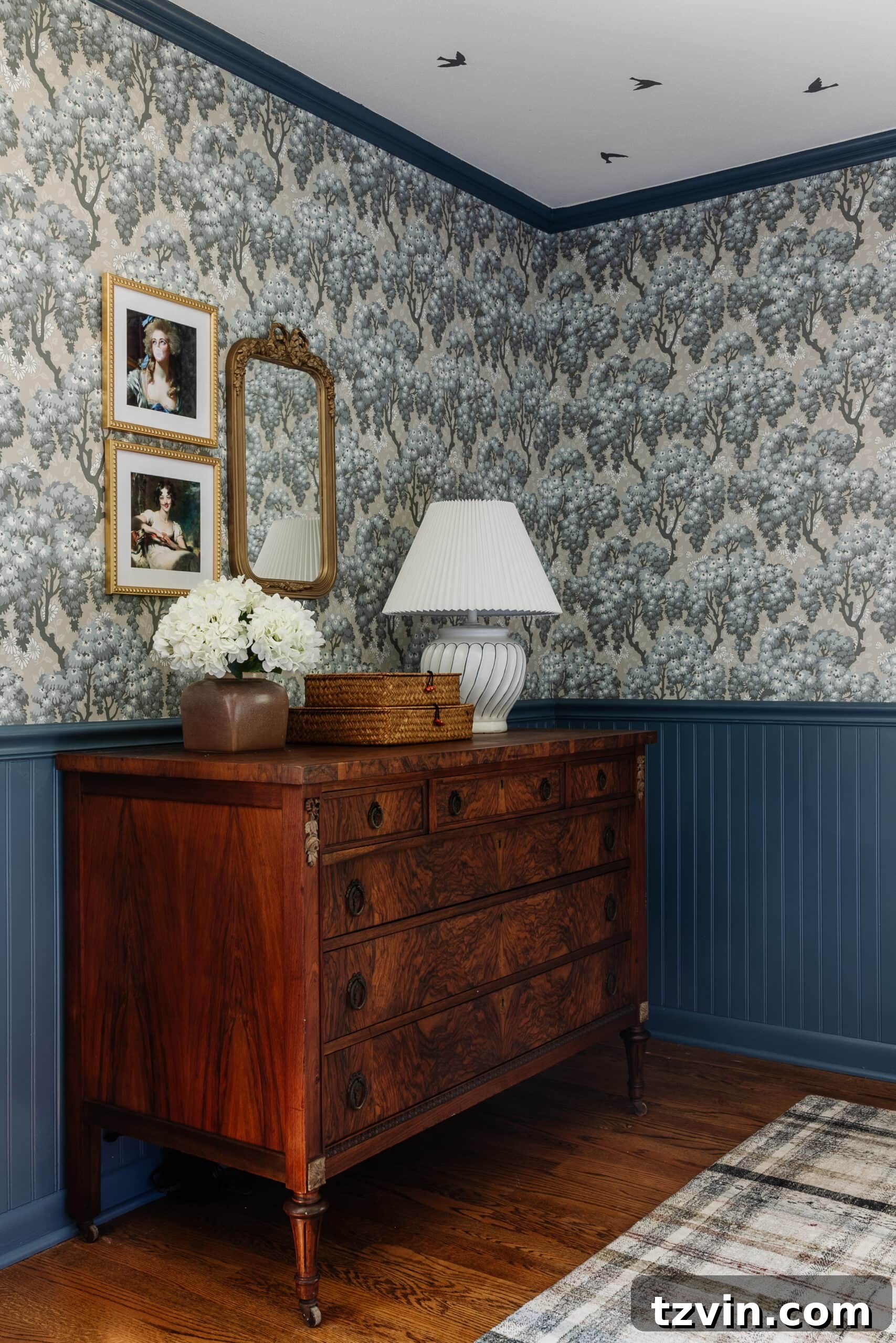 Burl wood dresser and altered portrait art in a Swedish cottage bedroom