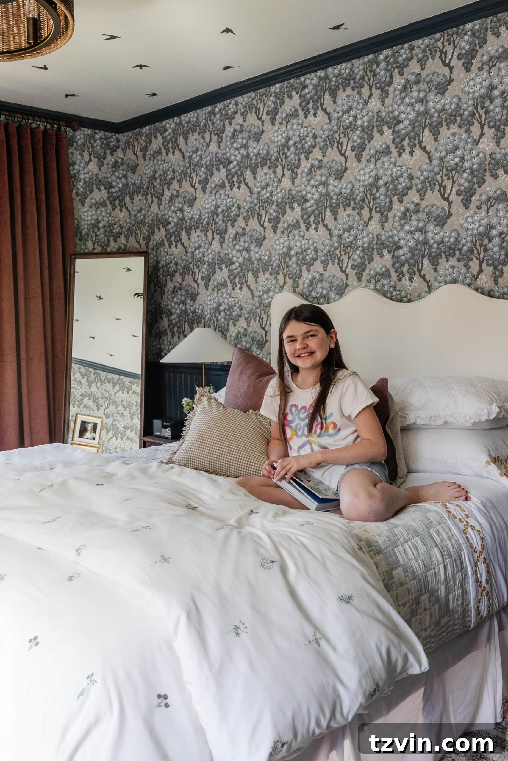 Girl on bed in swedish cottage bedroom