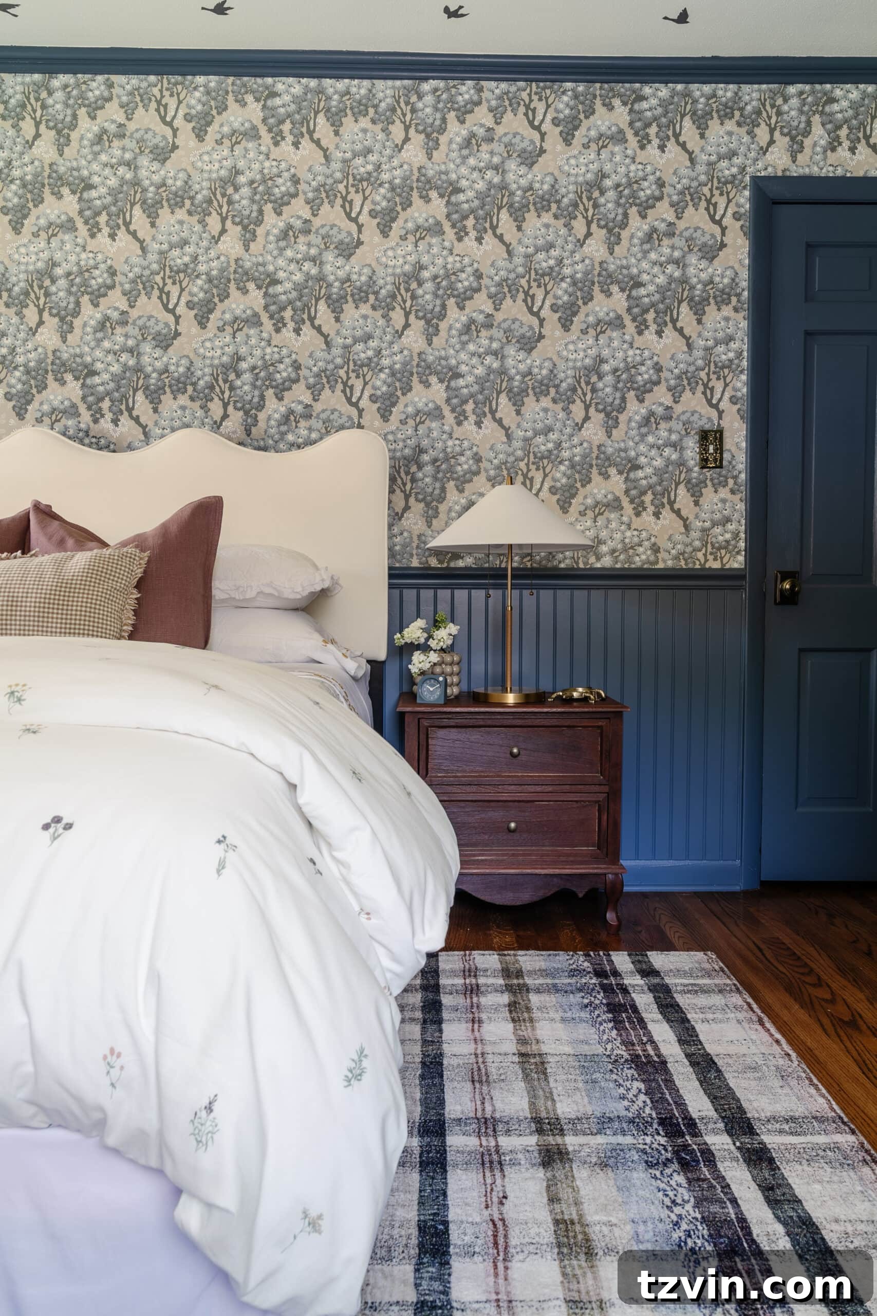 Swedish cottage girls bedroom with pattern play bedding, full length mirror, traditional wood nightstand, and modern lamp