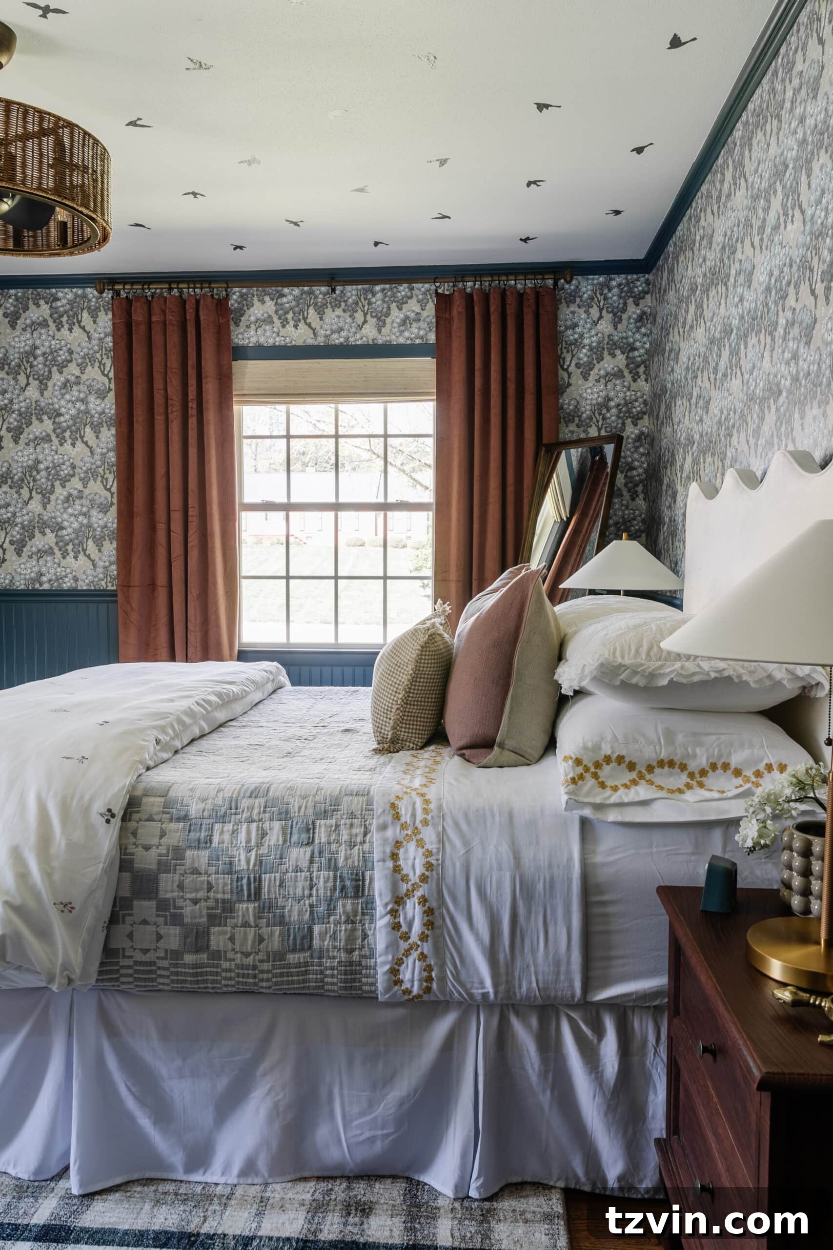 Girls bedroom with pattern play bedding, full length mirror, mauve curtains, and modern lamps
