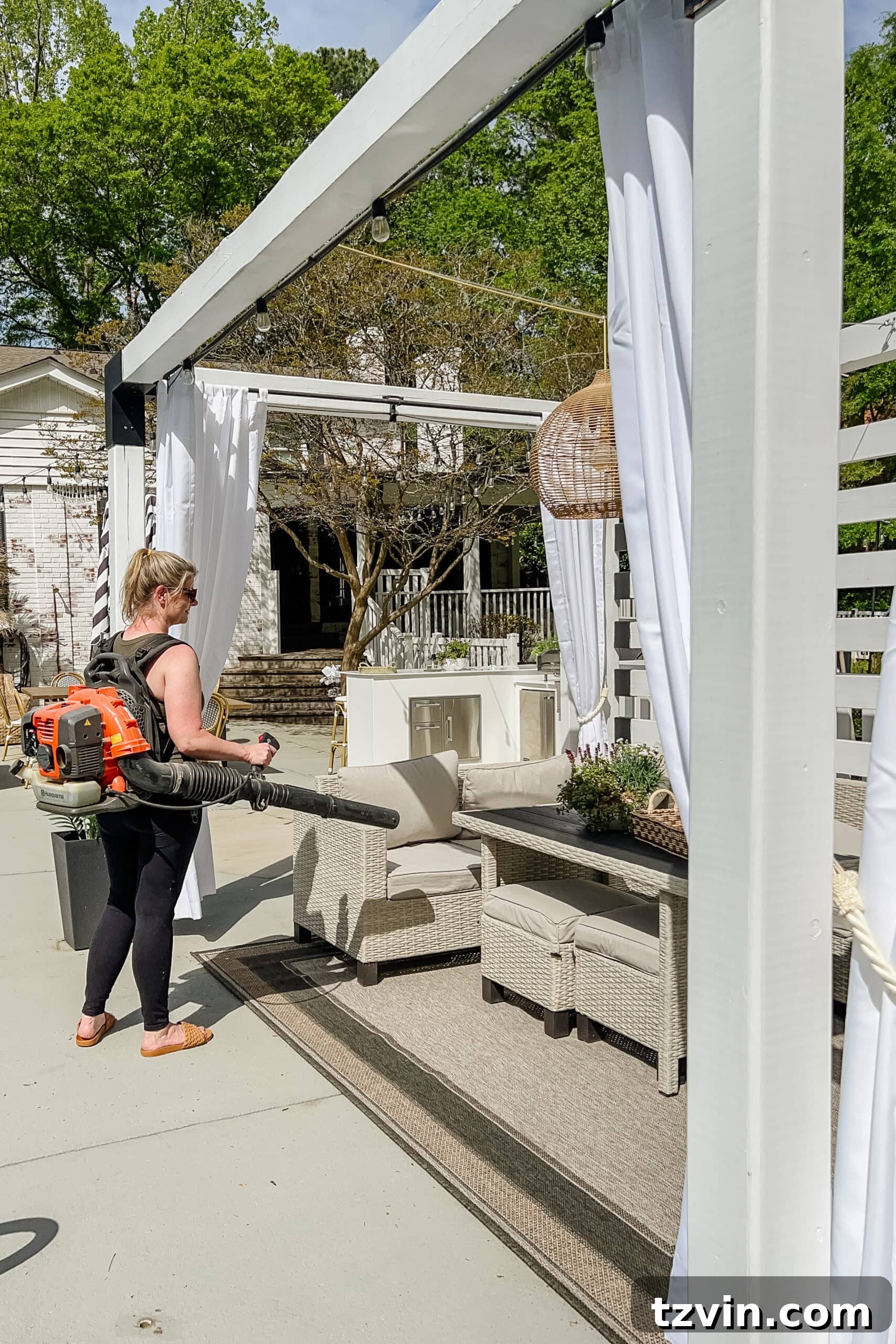 Spring Patio Refresh 16 cleaning debris on a patio using a leaf blower