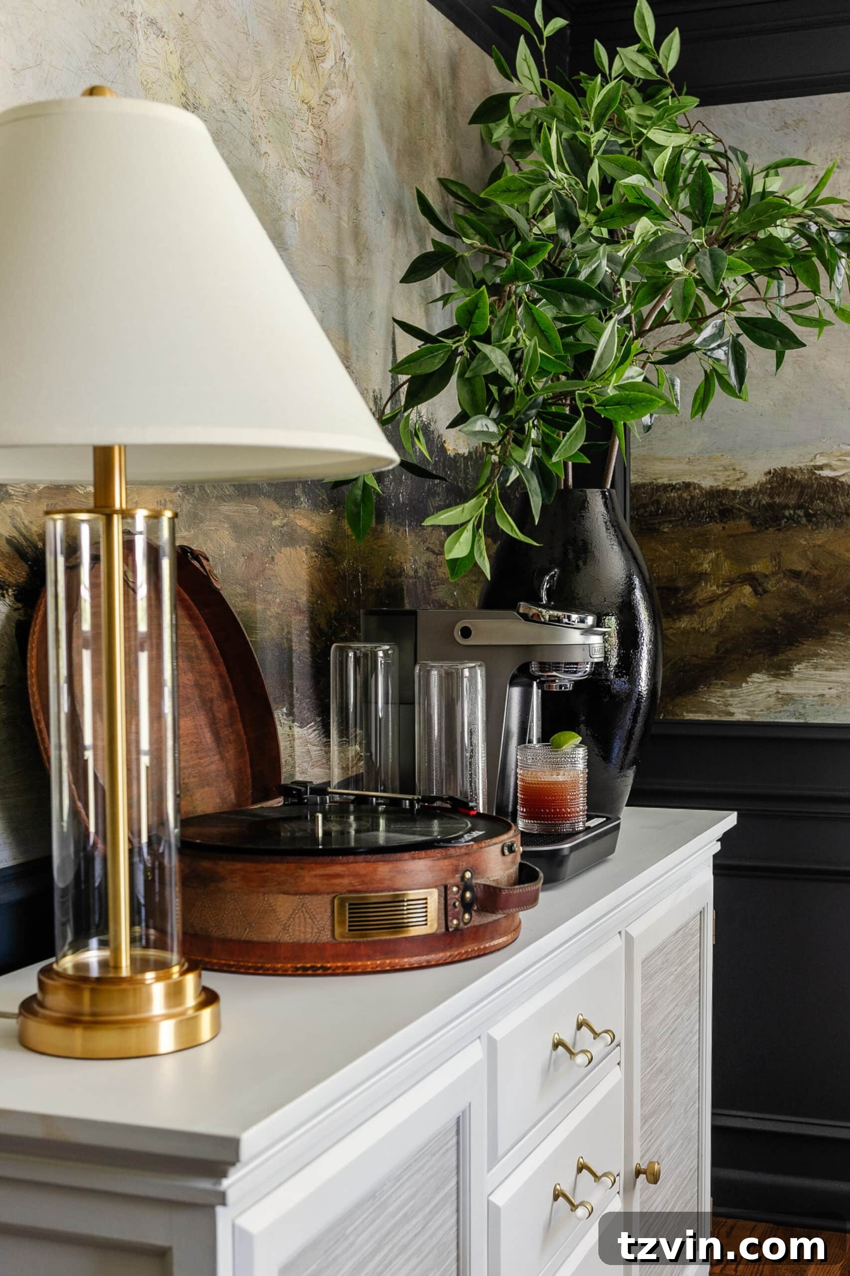 Bartesian Cocktail Maker: The Unvarnished Truth 6 drink machine on a dining room buffet sideboard with lamp, record player, and vase of branches