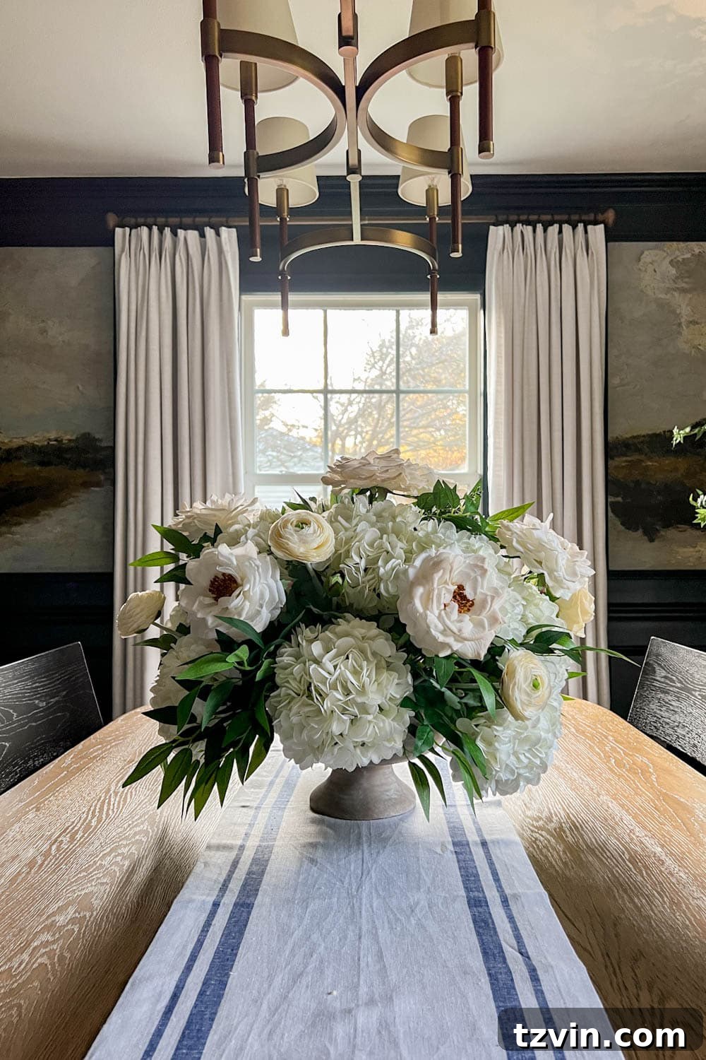 white flower arrangement wedding centerpiece with fake hydrangeas, roses, ranunculus, ruscus, and eucalyptus 