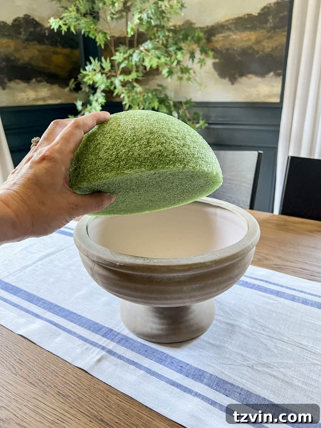 placing a half sphere of florist foam in a footed bowl to make DIY altar flower arrangement