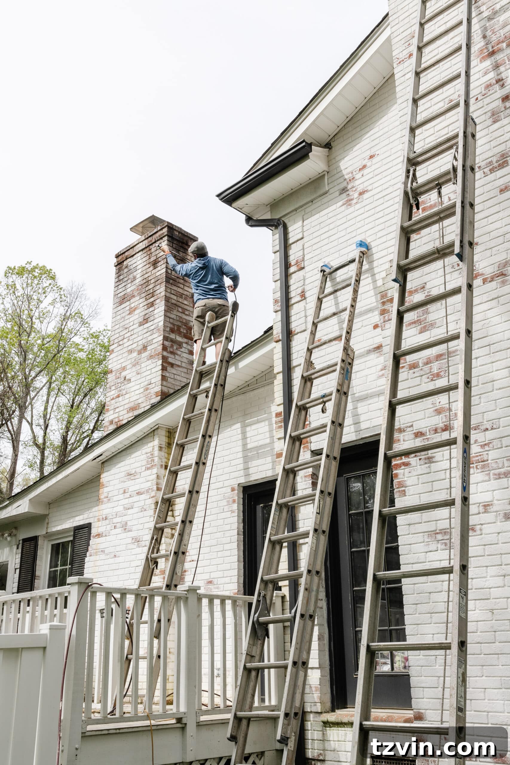 Mastering Limewashed Brick Cleaning and Upkeep 8 contractor on ladder cleaning limewashed chimney