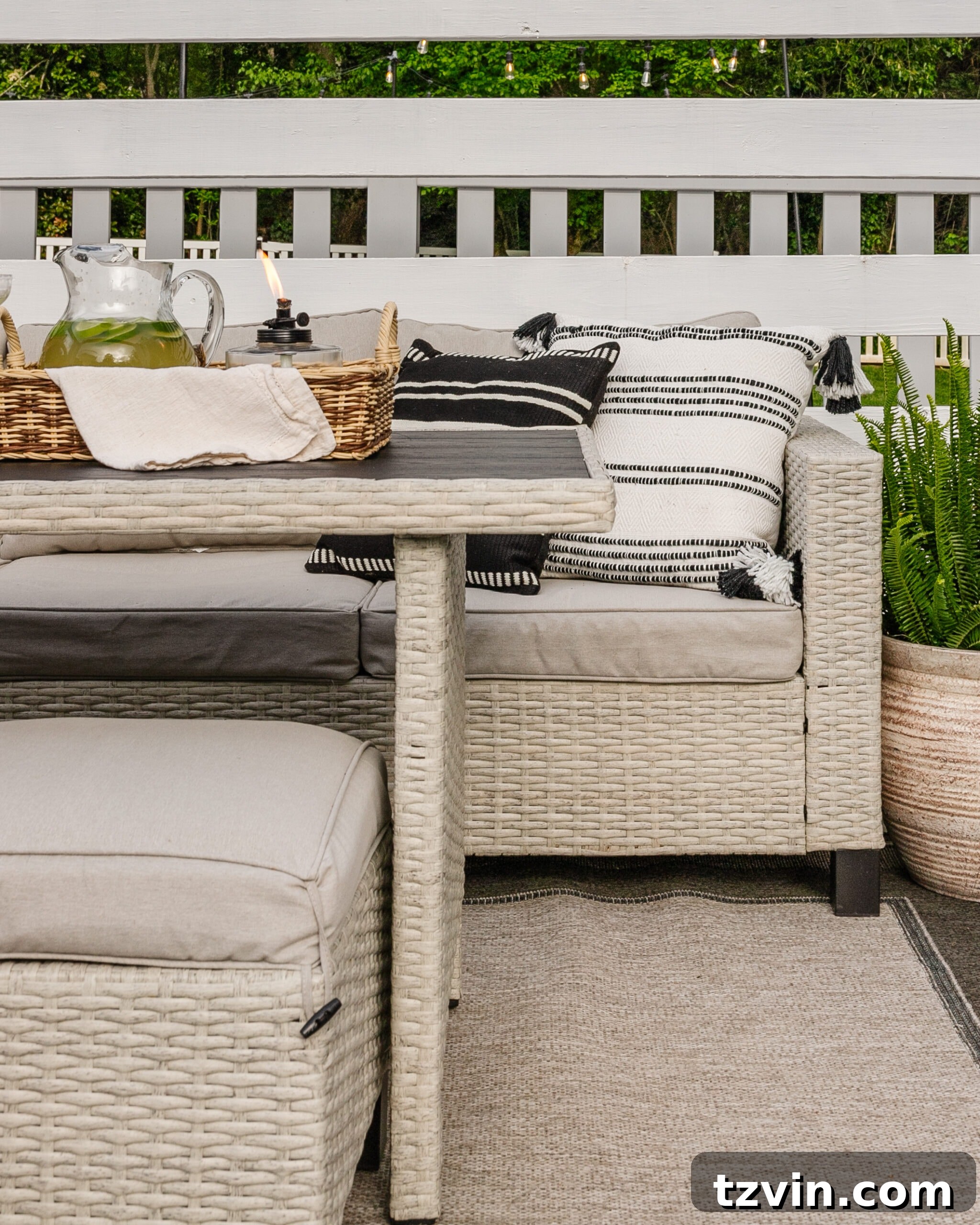 wicker patio dining set under a backyard pergola