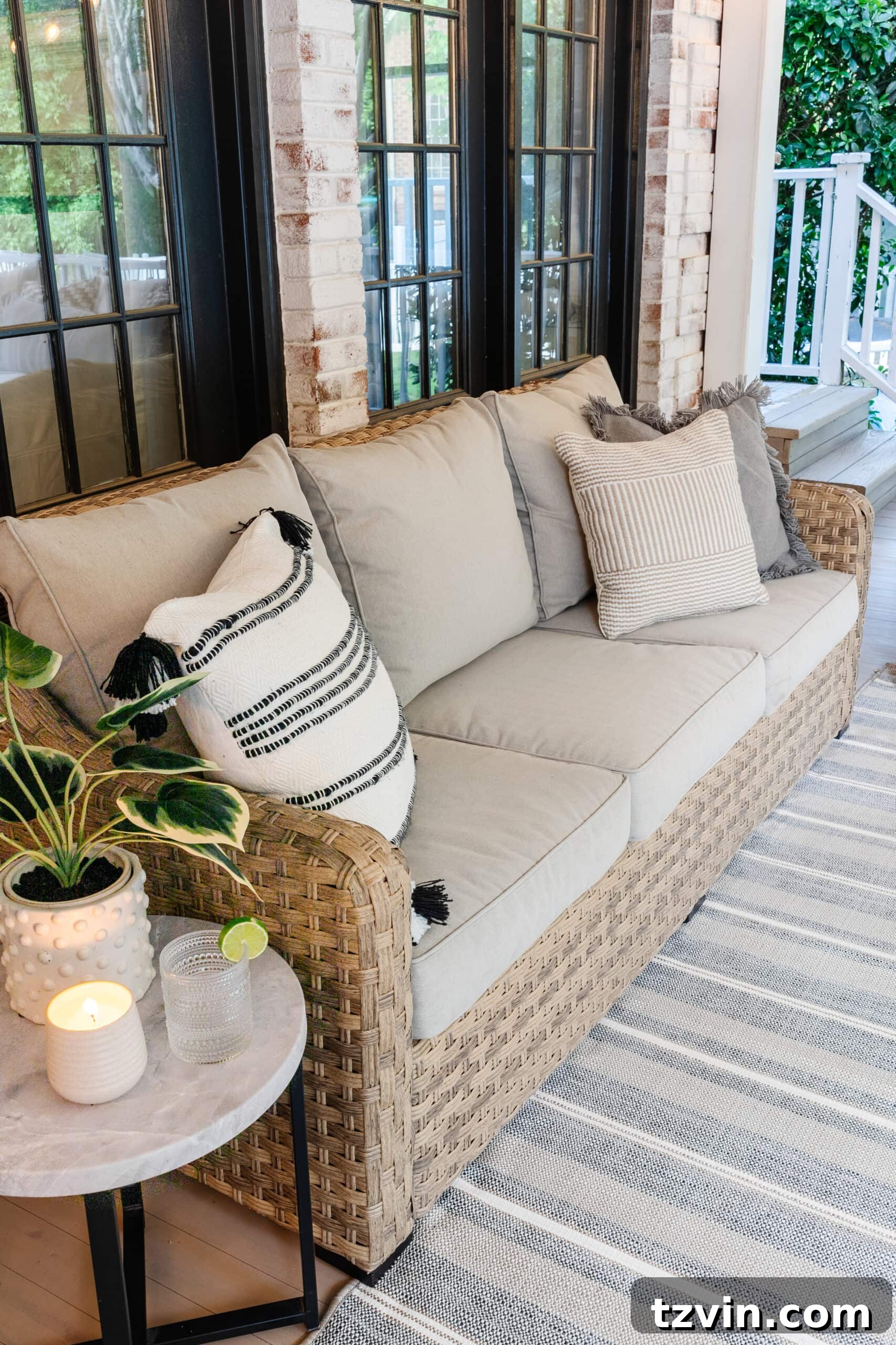 patio sofa on a back porch with neutral outdoor pillows 
