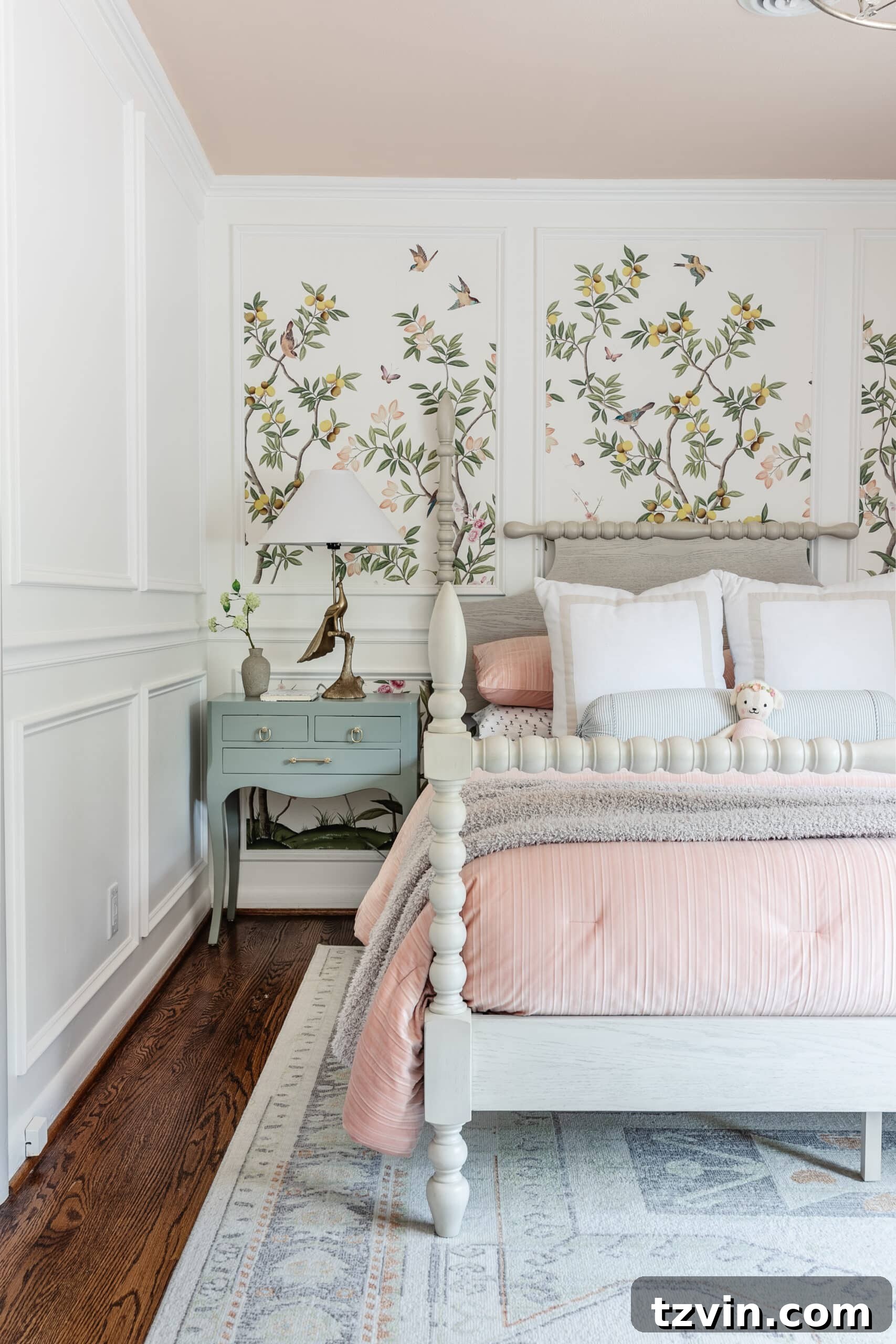 A wide shot of a charming bedroom featuring elegant chinoiserie wallpaper, a classic poster bed, and the newly gloss-painted mint green bedside table.