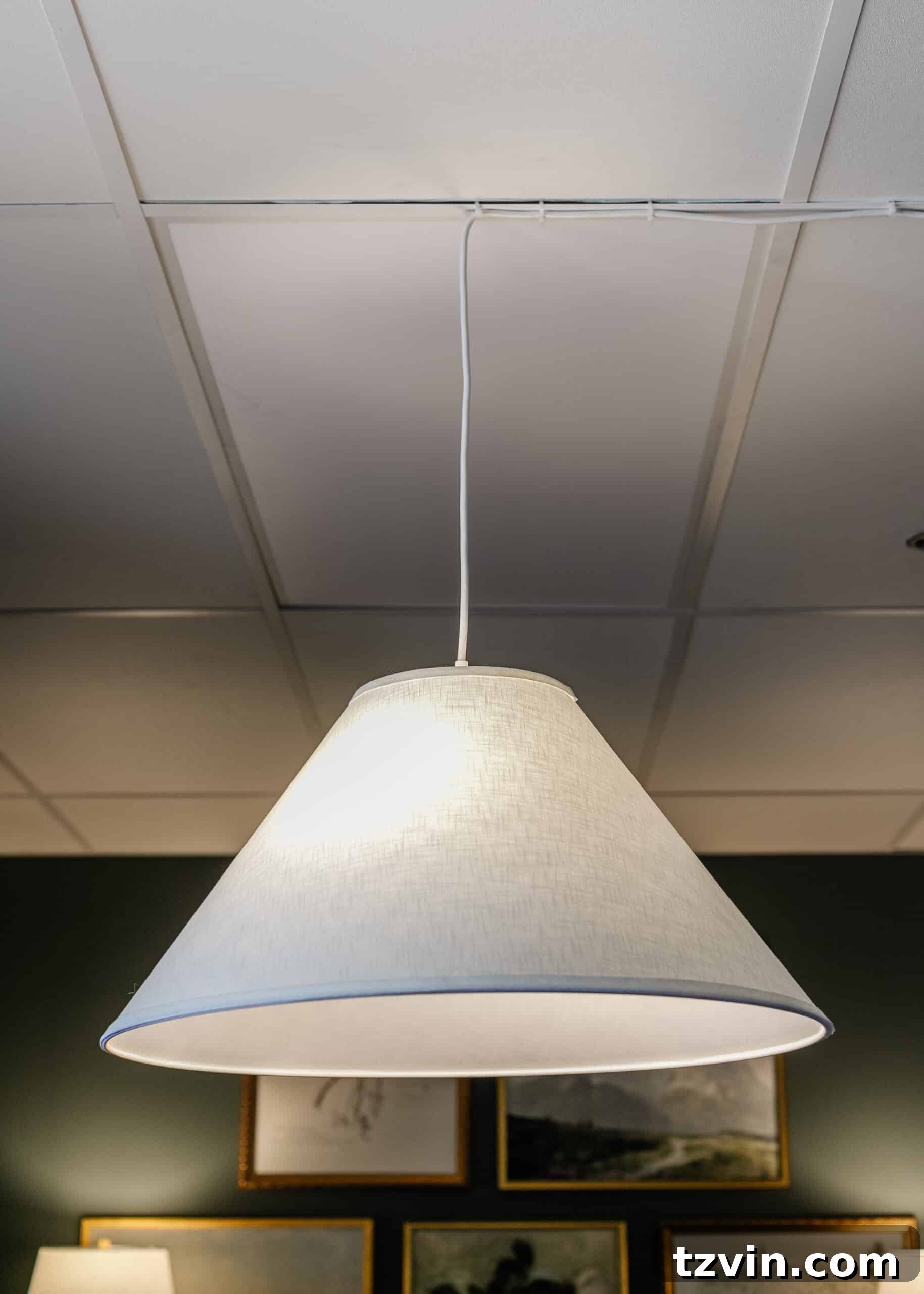 Warm Up Your Workday Cozy Conference Room Ideas for an Office Refresh 13 Innovative lighting solution in a conference room, showing a pendant lamp creatively installed from a drop ceiling to provide cozy illumination.