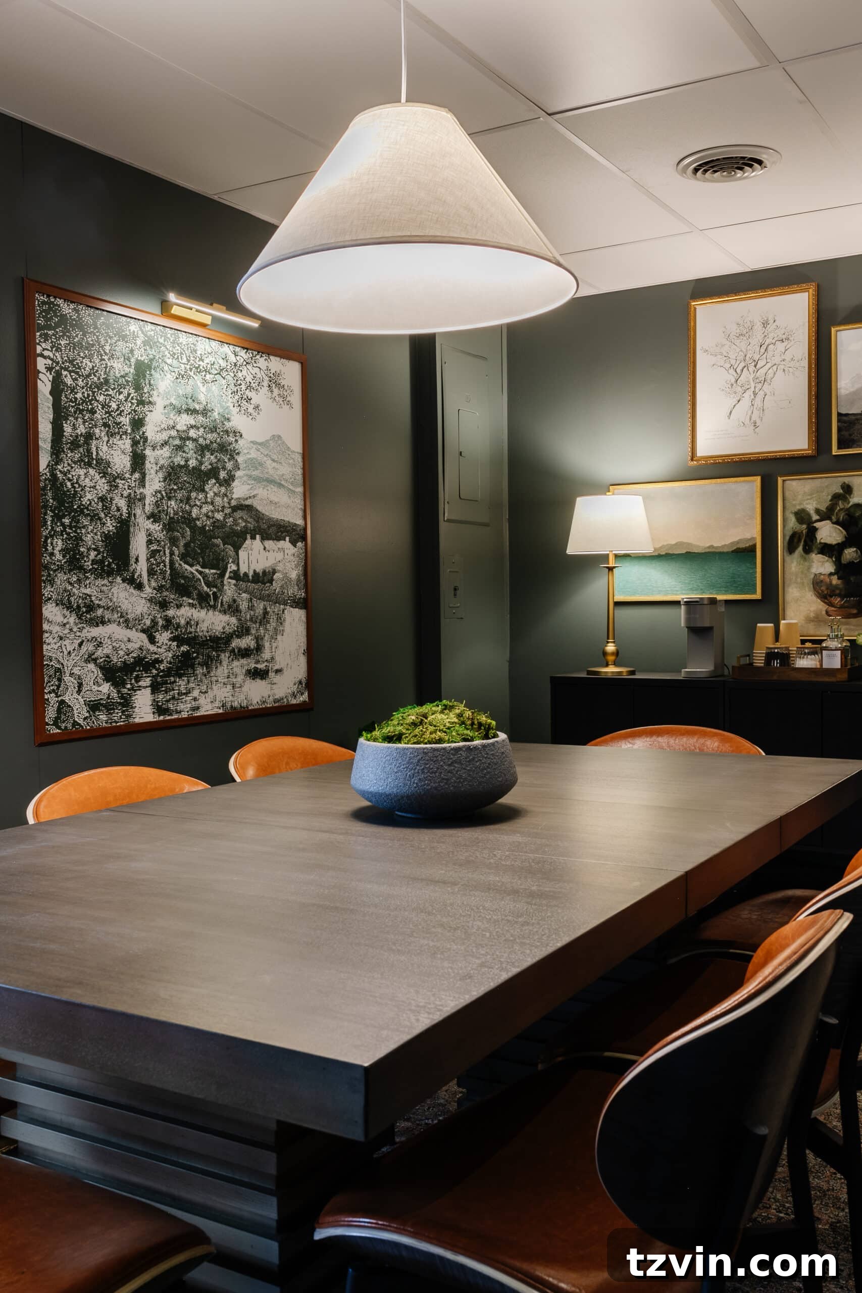 Warm Up Your Workday Cozy Conference Room Ideas for an Office Refresh 15 An inviting conference table and chairs bathed in the soft glow of a pendant lamp, illustrating the calming effect of warm lighting.